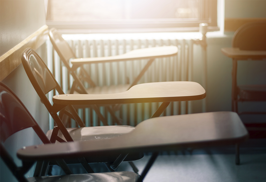 Three desks in a classroom