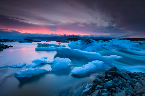 Icebergs floating in Jokulsarlon glacier lake at sunset