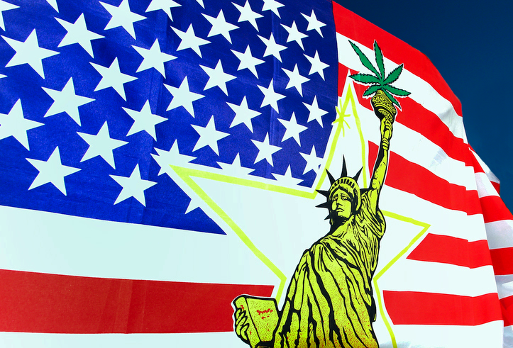 A yellow Statue of Liberty on top of an American flag