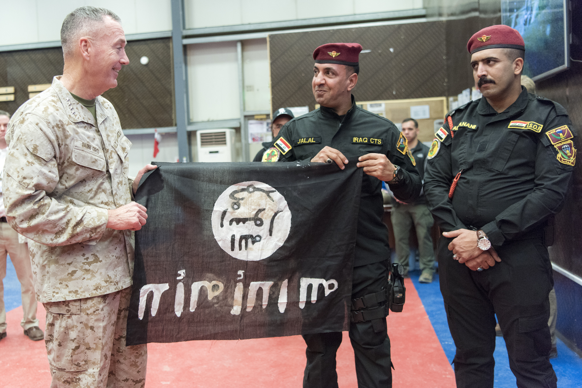 Members from the Iraqi Counter Terrorism Service present Marine Gen. Joseph F. Dunford, chairman of the Joint Chiefs of Staff, with a flag from Bartilah, a town recaptured just outside of Mosul from the Islamic State of Iraq and the Levant. This flag symbolizes the efforts of Combined Joint Task Force - Operation Inherent Resolve composed of U.S. Army Soldiers, U.S. Marine Corps Marines, U.S. Navy Sailors, United States Air Force Airmen and coalition military forces. (DoD Photo by Navy Petty Officer 2nd Class  Dominique A. Pineiro/released)