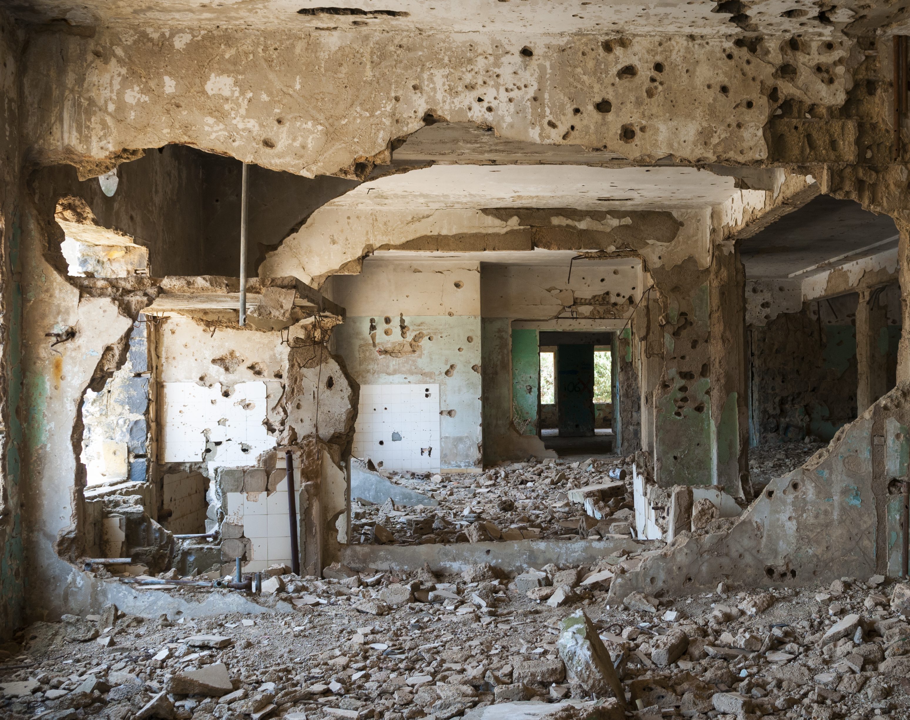 Interior view of the abandoned and bullet-scarred hospital in Quneitra, Syria. Quneitra was occupied by Israel for seven years beginning in 1967. Today, though decades have passed since the Israeli withdrawal, the town has been left in its destroyed state.