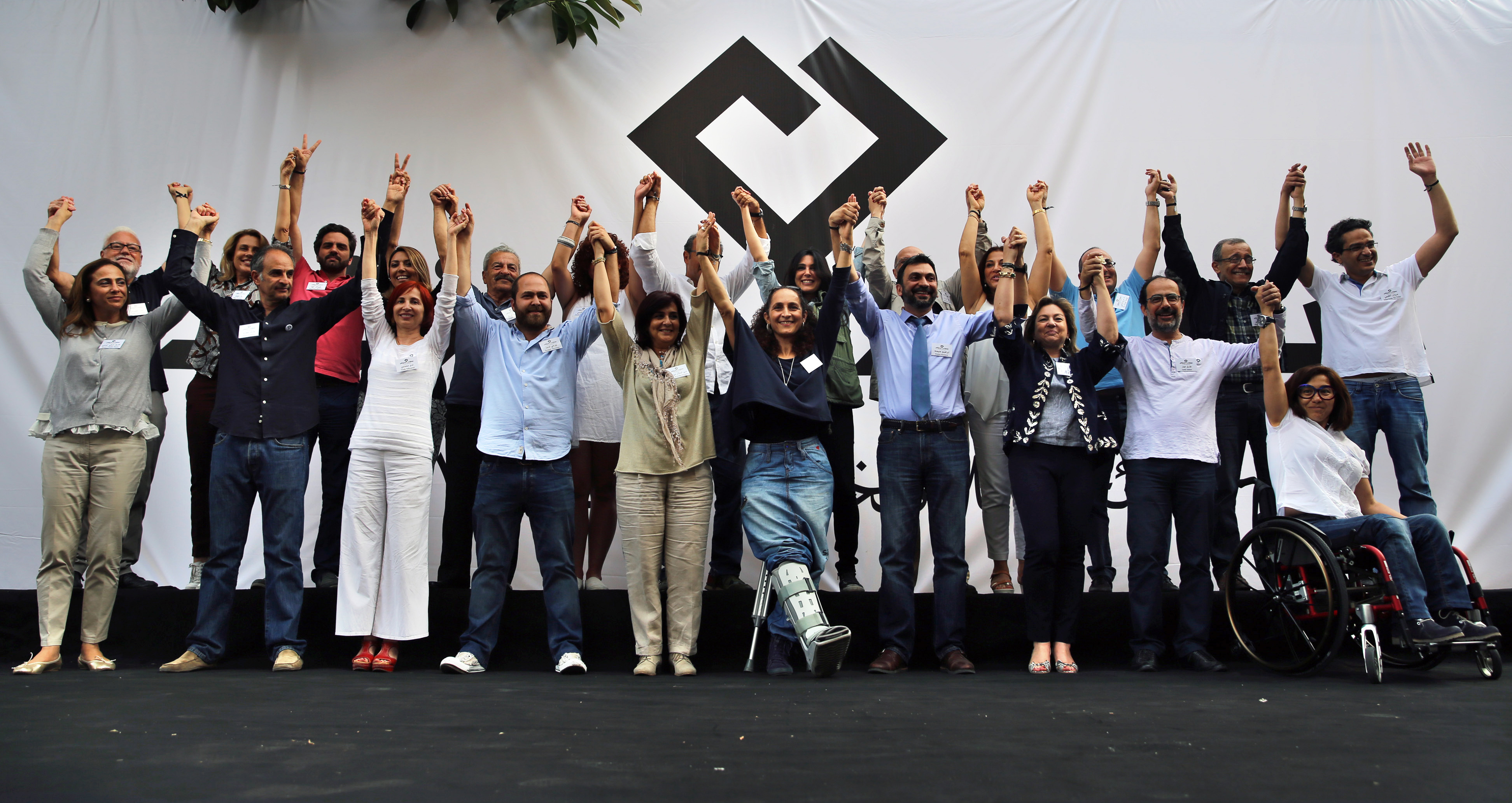In this Saturday, April 30, 2016 photo, members of Beirut Madinati, an electoral list for the upcoming Beirut municipality polls, raise their hands during an election rally in Beirut, Lebanon. (AP Photo/Bilal Hussein)