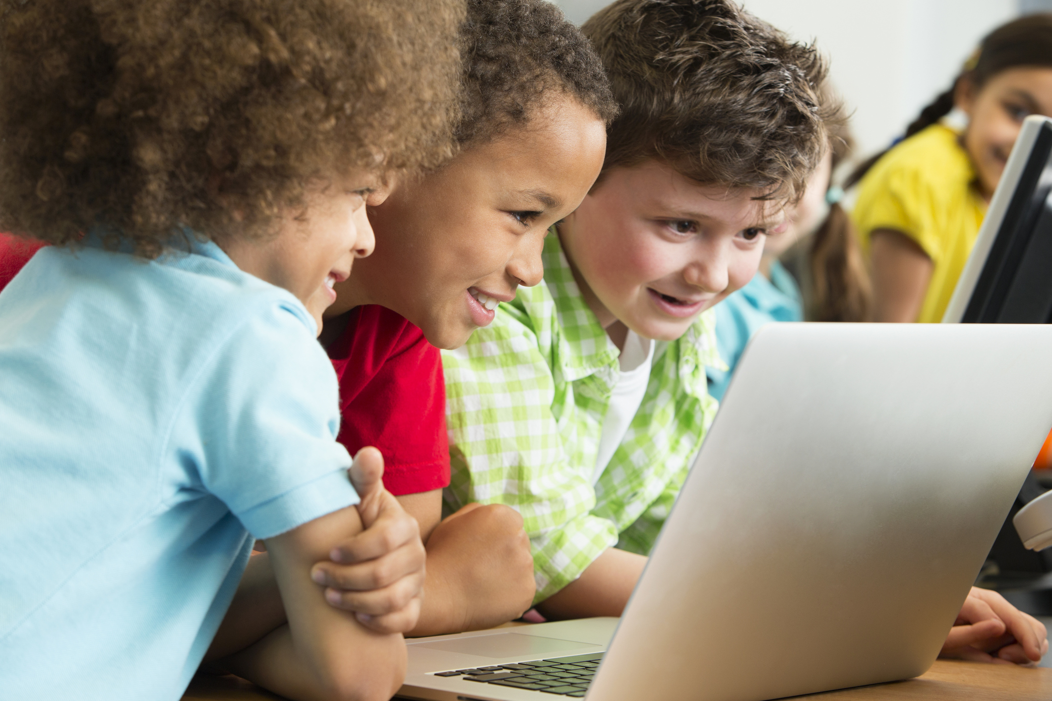 Preschool children looking on a laptop
