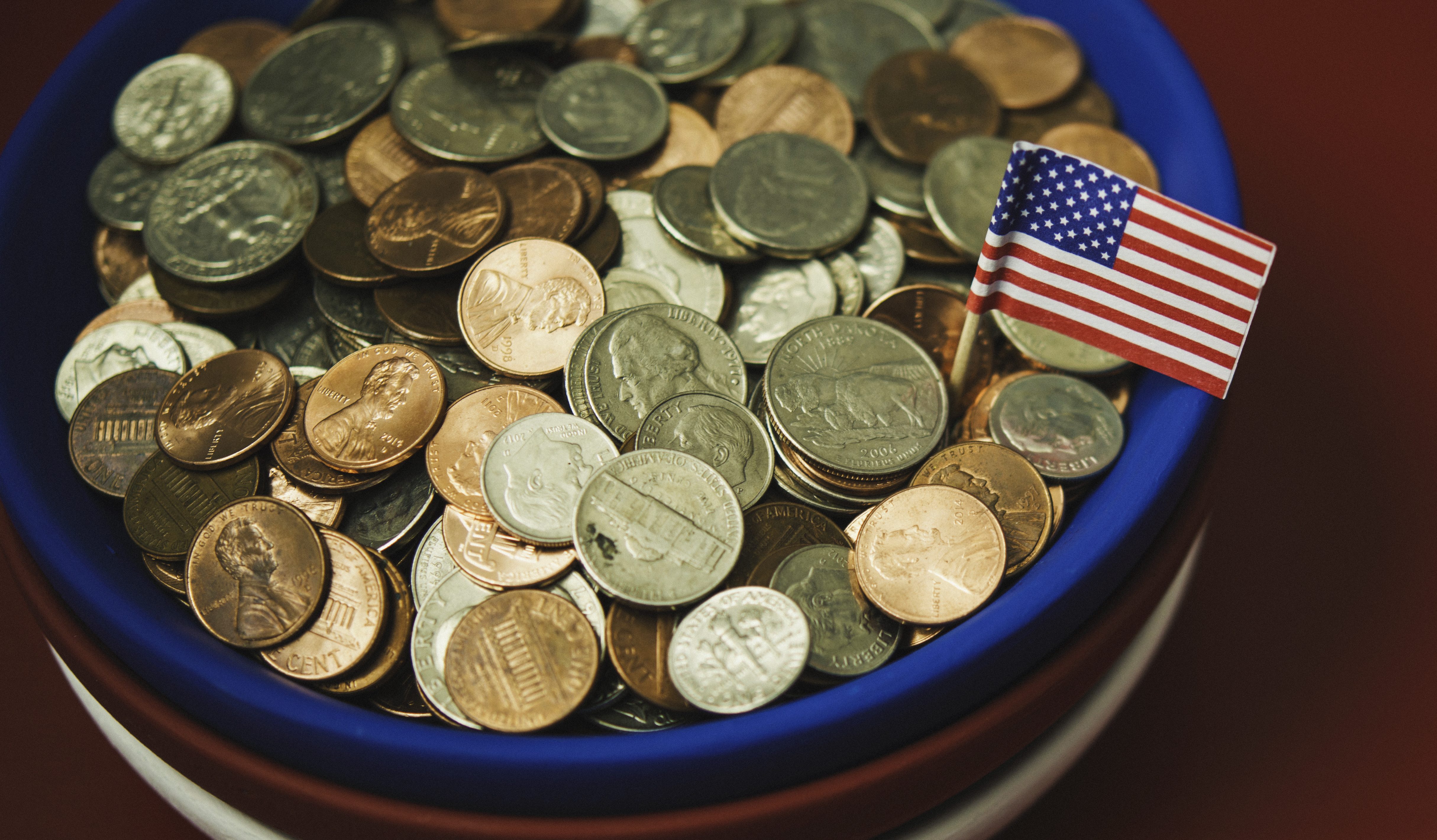 Bowl filled with cash in patriotic colors. Charity and donation theme
