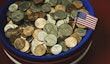 Bowl filled with cash in patriotic colors. Charity and donation theme