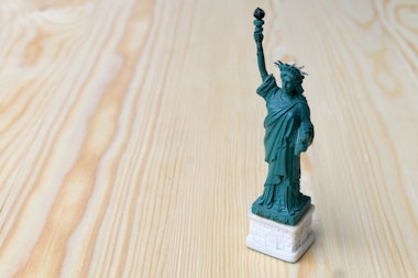 American symbol - Statue of Liberty. New York, USA on wooden table with background.American symbol - Statue of Liberty. New York, USA on wooden table with background.