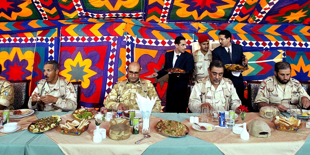 SALMI, KUWAIT - MARCH 25:  Members of the Peninsula Shield force eat lunch at a security station 25 miles from the Kuwait-Iraq border March 25, 2003 in Salmi, Kuwait. The 10,000 man unit combines forces from member states of the Gulf Cooperation Council (GCC)- Saudi Arabia, United Arab Emirates, Oman, Bahrain, Qatar and Kuwait in an effort to help defend the joint border of Saudi Arabia, Kuwait and Iraq.  (Photo by Mario Tama/Getty Images)