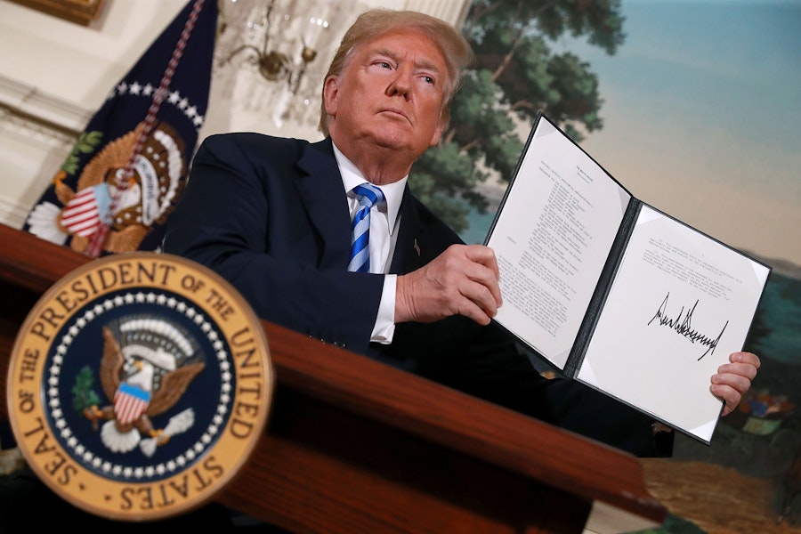 WASHINGTON, DC - MAY 08:  U.S. President Donald Trump holds up a memorandum that reinstates sanctions on Iran after he announced his decision to withdraw the United States from the 2015 Iran nuclear deal in the Diplomatic Room at the White House May 8, 2018 in Washington, DC. After two and a half years of negotiations, Iran agreed in 2015 to end its nuclear program in exchange for Western countries, including the United States, lifting decades of economic sanctions. Since then international inspectors have not found any violations of the terms by Iran.  (Photo by Chip Somodevilla/Getty Images)