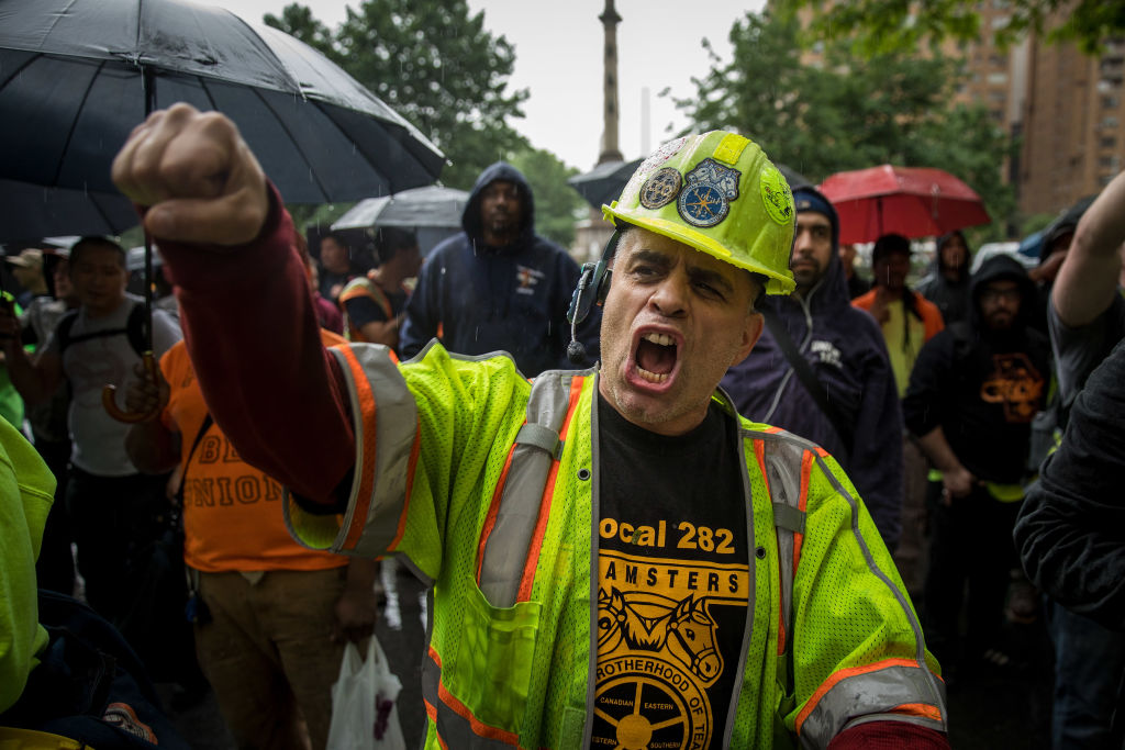 NEW YORK, NY - MAY 22: Construction workers and union members hold a rally in Columbus Circle, May 22, 2018 in New York City. On Monday, the Supreme Court delivered a 5-4 ruling stating that companies can use arbitration clauses in employee contracts to prohibit them from filing class-action lawsuits concerning workplace issues. Unions and workers' rights advocates are also awaiting an expected June ruling by the Supreme Court in the Janus v. AFSCME case, which could give government workers nationwide the choice of opting out of paying union fees even if they benefit from the union's contract negotiations.(Photo by Drew Angerer/Getty Images)