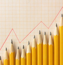 Aligned graphite pencils below red graph