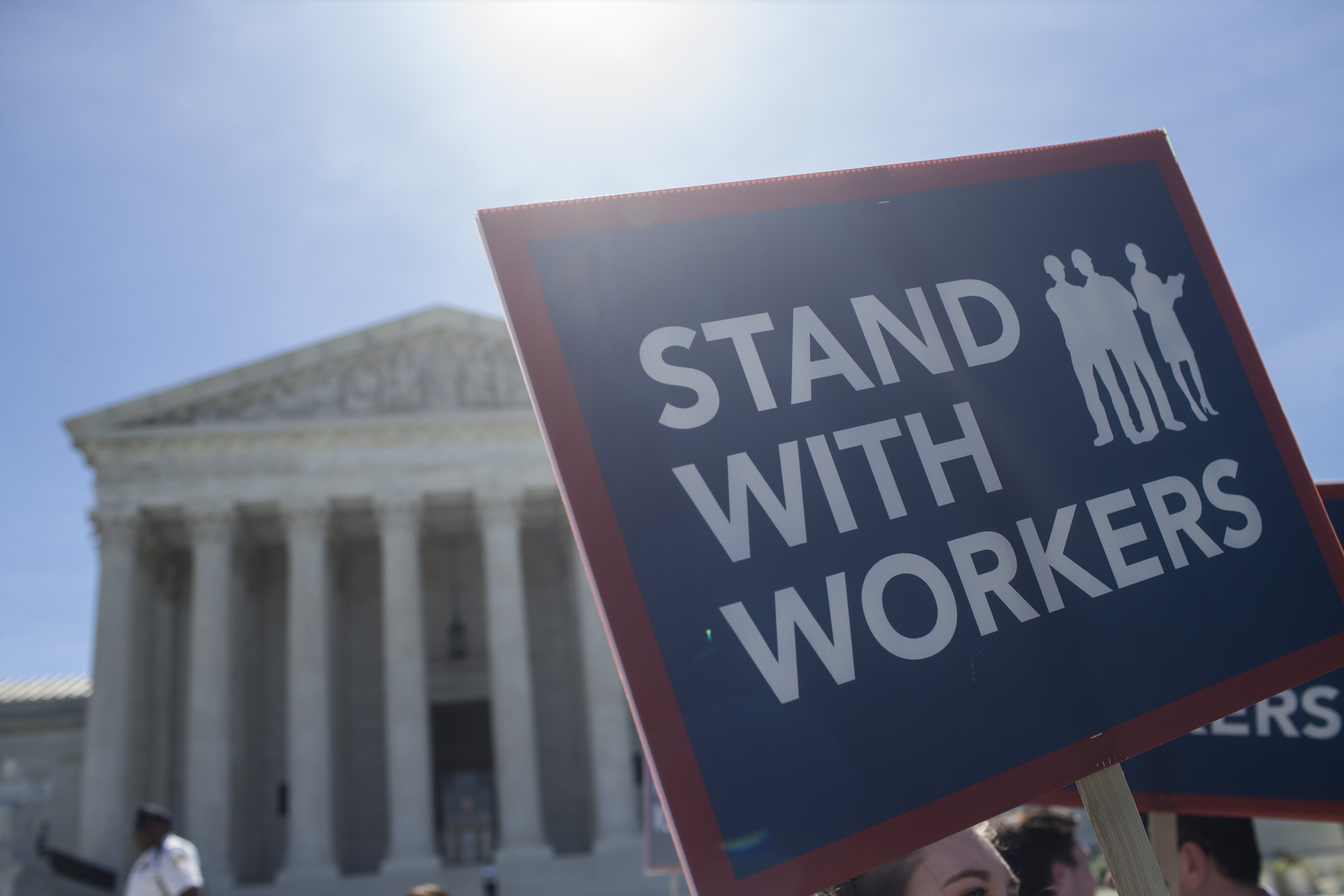 WASHINGTON, DC - JUNE 25: A demonstrator holds a sign in front of the U.S. Supreme Court on June 25, 2018 in Washington, DC. The high court is expected to issue decisions in six remaining cases, including the travel ban, public sector unions and redistricting, ahead of their end-of-June deadline this week.  (Photo by Zach Gibson/Getty Images)