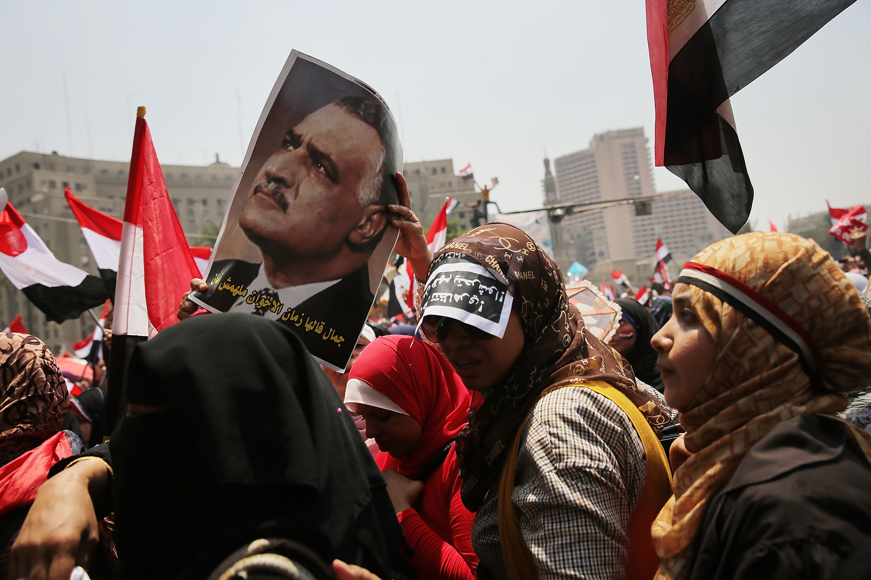 CAIRO, EGYPT - JULY 03:  Holding a picture of the second President of Egypt Gamal Abdel Nasser Hussein, hundreds of Egyptian protesters begin to gather in Tahrir Square as the deadline given by the military to Egyptian President Mohammed Morsi approaches on July 3, 2013 in Cairo, Egypt. The president gave a defiant speech last night and vowed to stay in power despite the military threats. As unrest spreads throughout the country, at least 23 people were killed in Cairo on Tuesday and over 200 others were injured.  (Photo by Spencer Platt/Getty Images)
