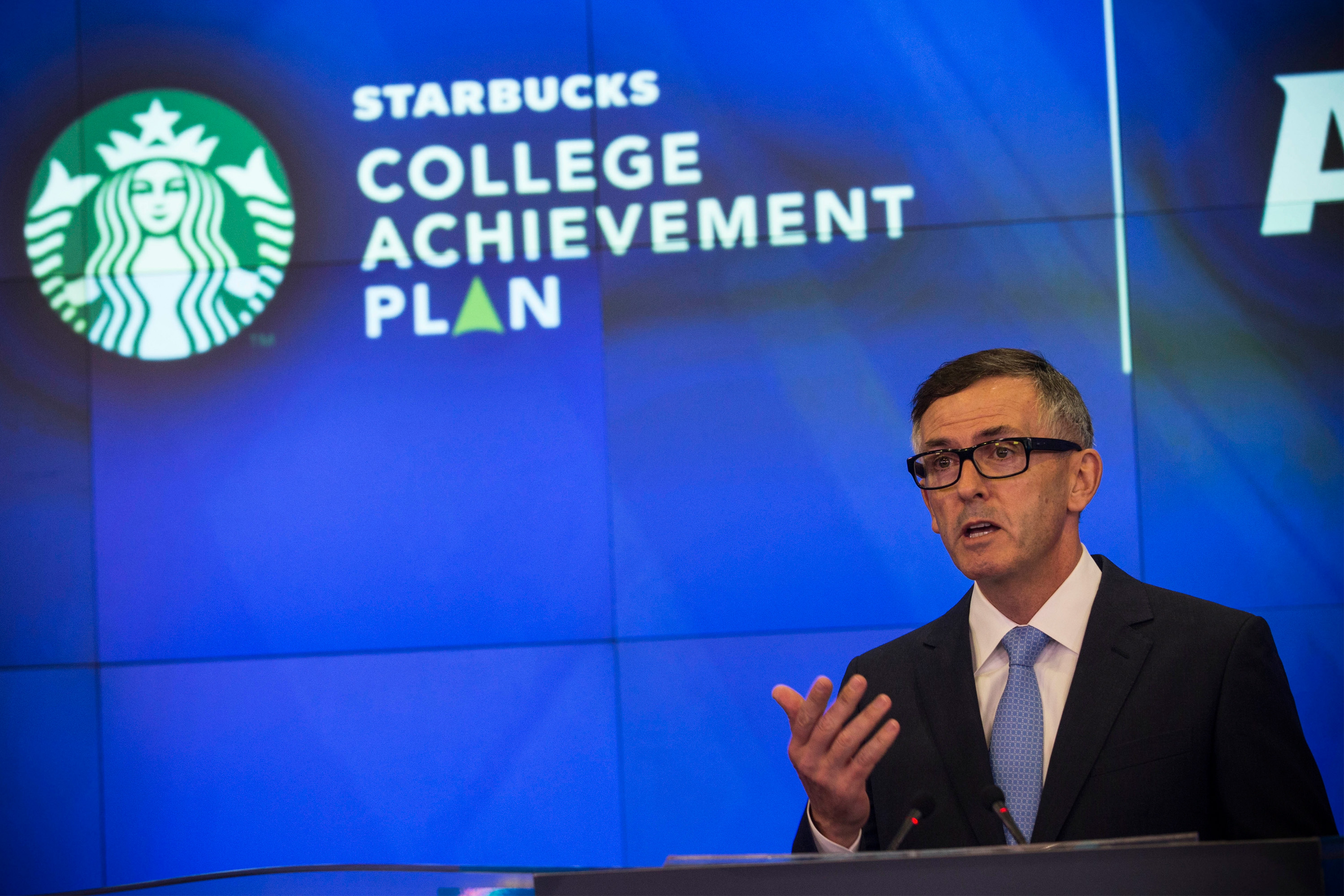 NEW YORK, NY - JUNE 17:  Cliff Burrows, group president for Starbucks in the Americas and Teavana, speaks at the opening bell of the Nasdaq Stock Exchange on June 17, 2014 in New York City. Starbucks announced a partnership with Arizona State University (ASU) yesterday, where Starbucks employees will be able to go to school online through ASU and Starbucks will pay for tuition.  (Photo by Andrew Burton/Getty Images)
