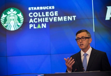 NEW YORK, NY - JUNE 17: Cliff Burrows, group president for Starbucks in the Americas and Teavana, speaks at the opening bell of the Nasdaq Stock Exchange on June 17, 2014 in New York City. Starbucks announced a partnership with Arizona State University (ASU) yesterday, where Starbucks employees will be able to go to school online through ASU and Starbucks will pay for tuition. (Photo by Andrew Burton/Getty Images)