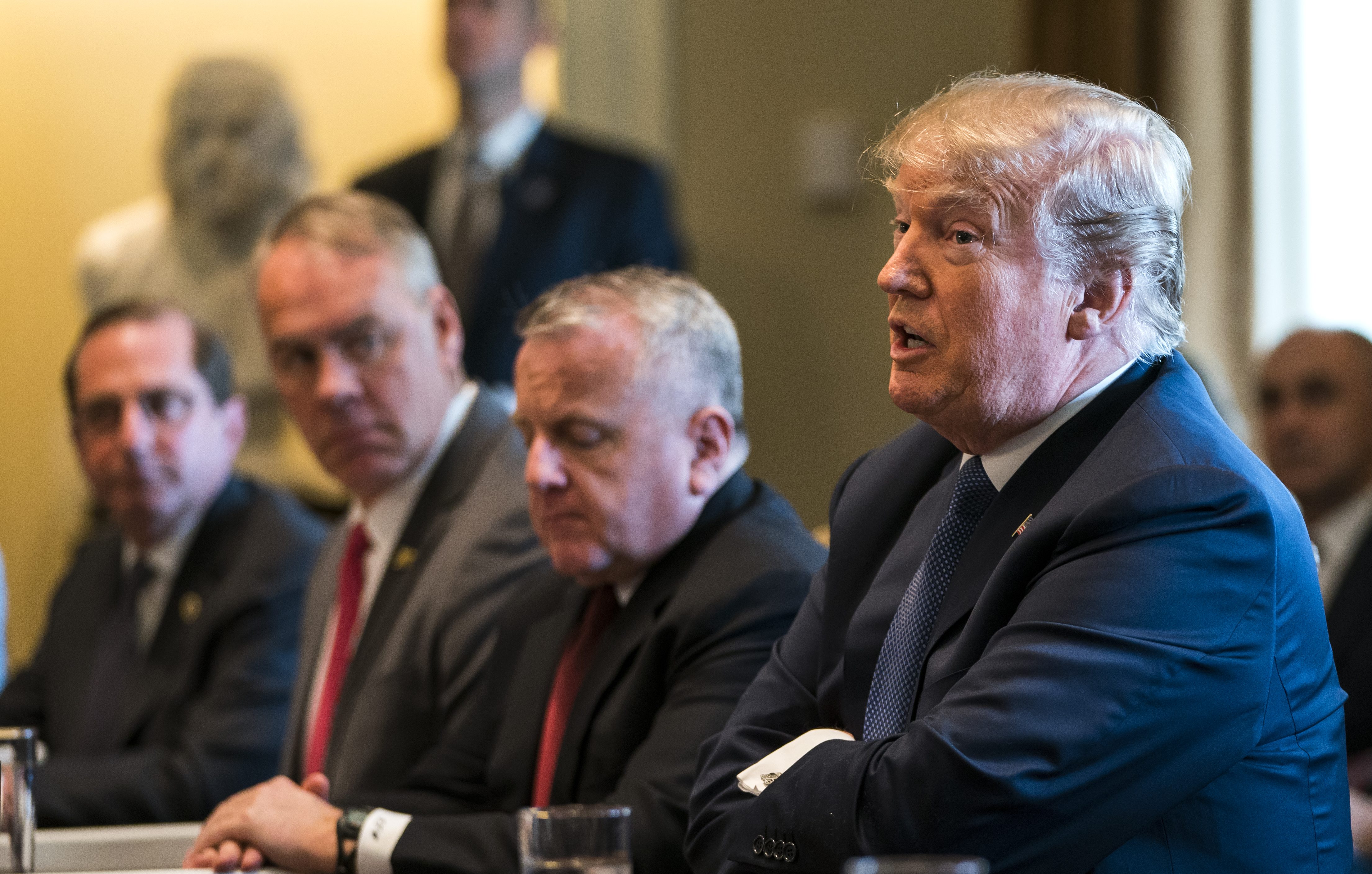 WASHINGTON, DC - APRIL 9: (AFP OUT) U.S. President Donald J. Trump (C) speaks with the media before a meeting with his cabinet in the Cabinet Room of the White House April 9, 2018 in Washington DC. Trump said he will decide in the next few days whether  the US will respond militarily for the reported chemical weapons attack in Syria. (Photo by Jim Lo Scalzo-Pool/Getty Images)