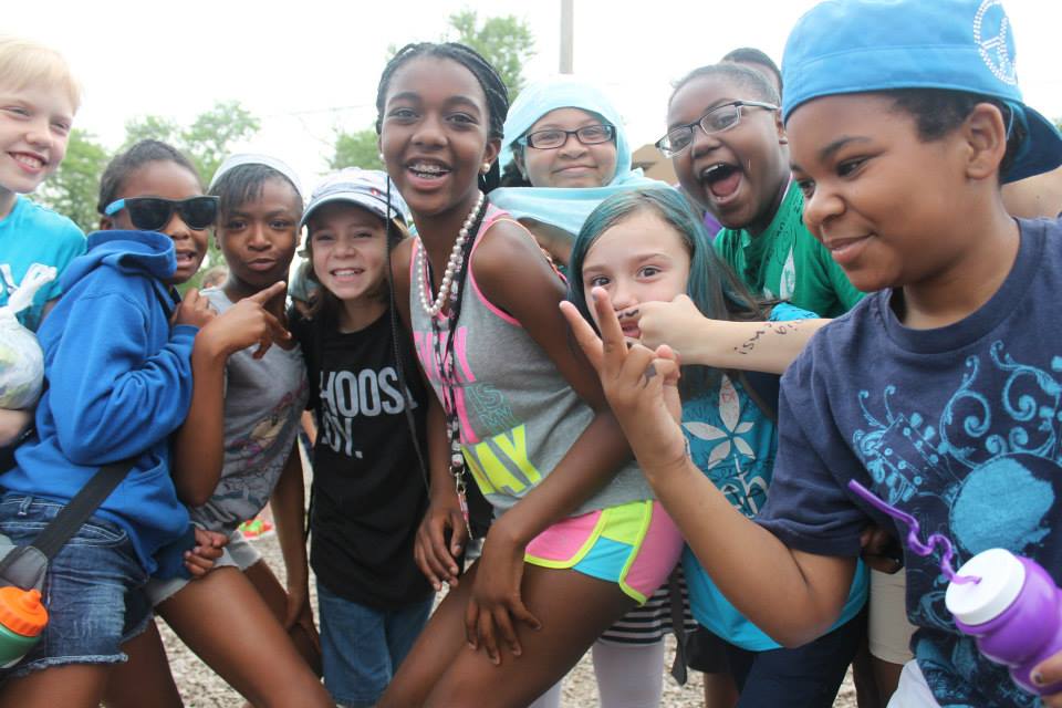 a group of young children standing next to each other