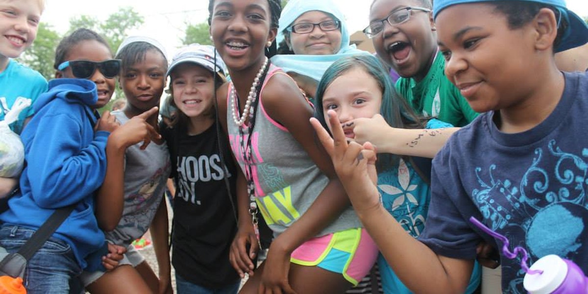 a group of young children standing next to each other