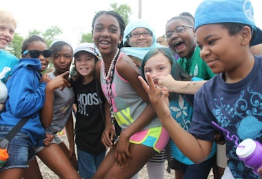 a group of young children standing next to each other