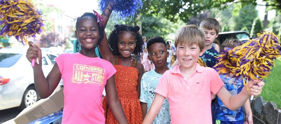a group of young children standing next to each other
