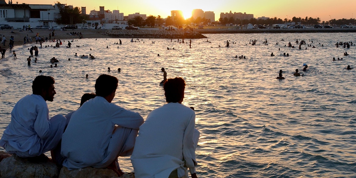 People watching the sunset along the beach.