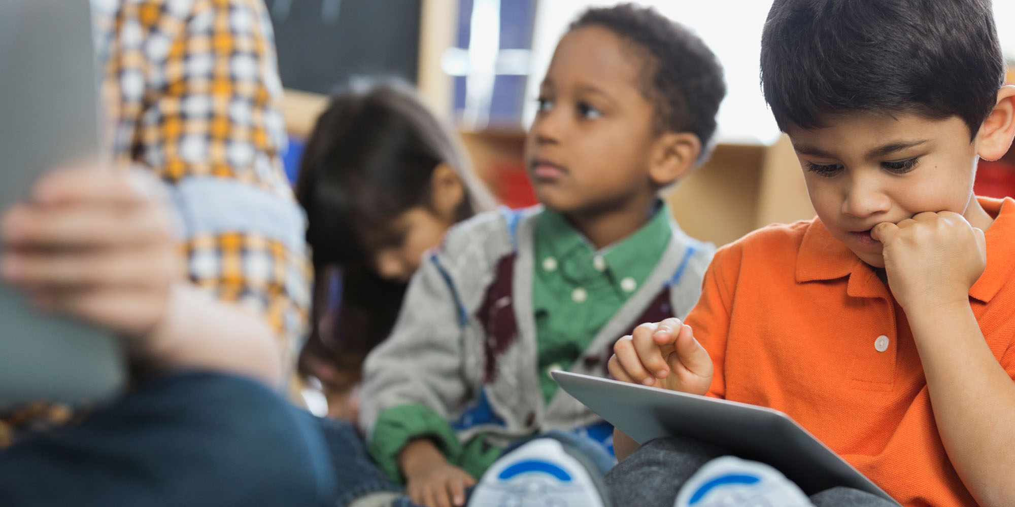 a group of young children sitting next to each other