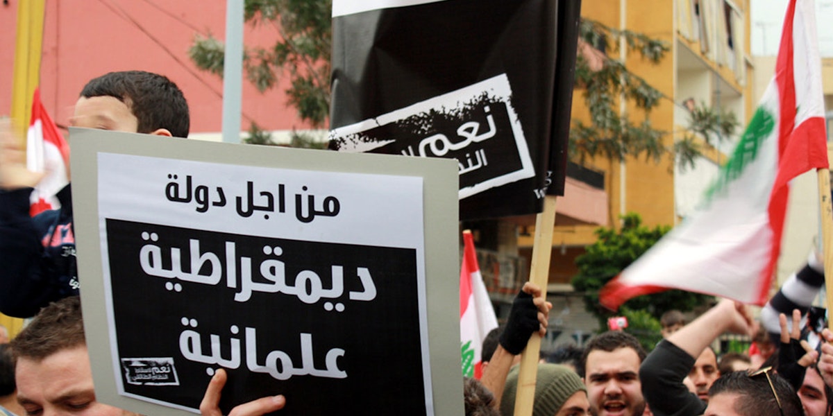a group of people holding signs and flags