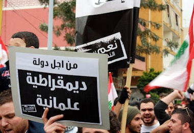 a group of people holding signs and flags