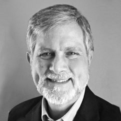 a black and white photo of a man in a suit