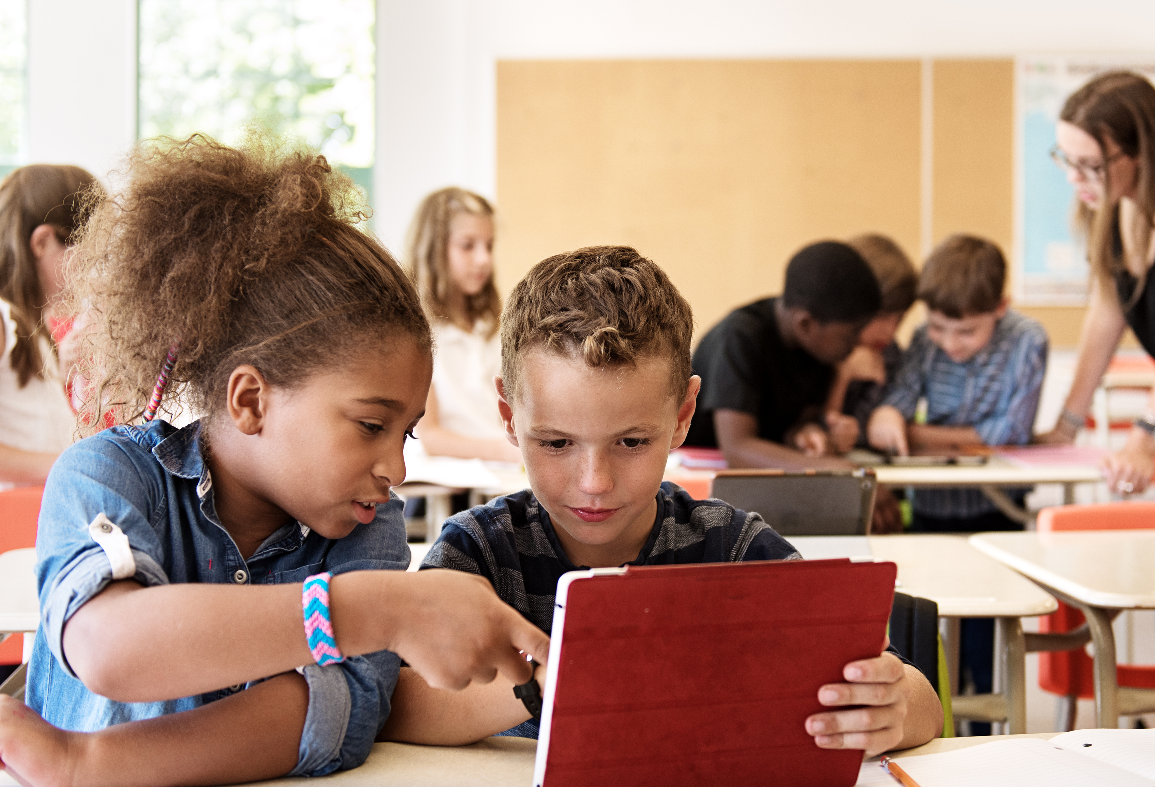 A photograph of children reading a book together.