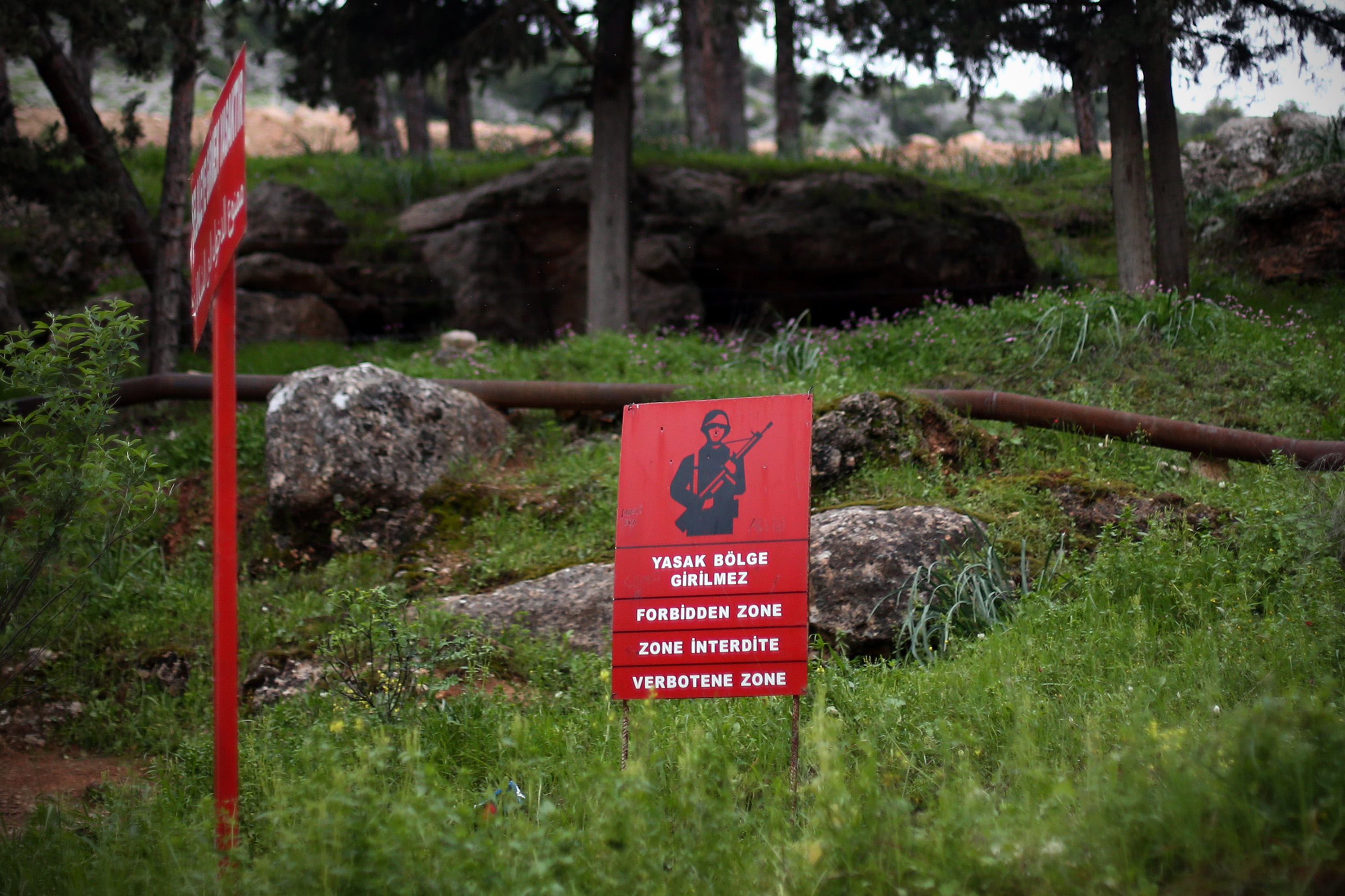 REYHANLI, TURKEY - MARCH 23:  A Turkish military 'forbidden zone' sign is pictured near the Turkish border wth Syria on March 23, 2015 in Reyhanli, Turkey. Although it has recently closed its entire border with Syria, Turkey has one of the largest populations of Syrian refugees with official estimates currently at 1.6 million. Border towns such as Reyhanli have received a large number of refugees though other refugees have settled as far afield as Istanbul.  (Photo by Carl Court/Getty Images)