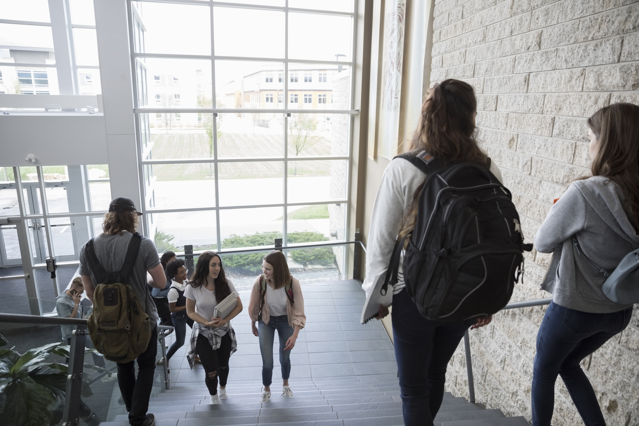 a group of people walking up a flight of stairs