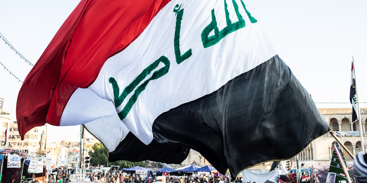 BAGHDAD, IRAQ - NOVEMBER 21: A flag waves over Tahrir Square on November 21, 2019 in Baghdad, Iraq. Thousands of demonstrators have occupied Baghdad's center Tahrir Square since October 1, calling for government and policy reform. For many, Tahrir Square, which protesters are calling