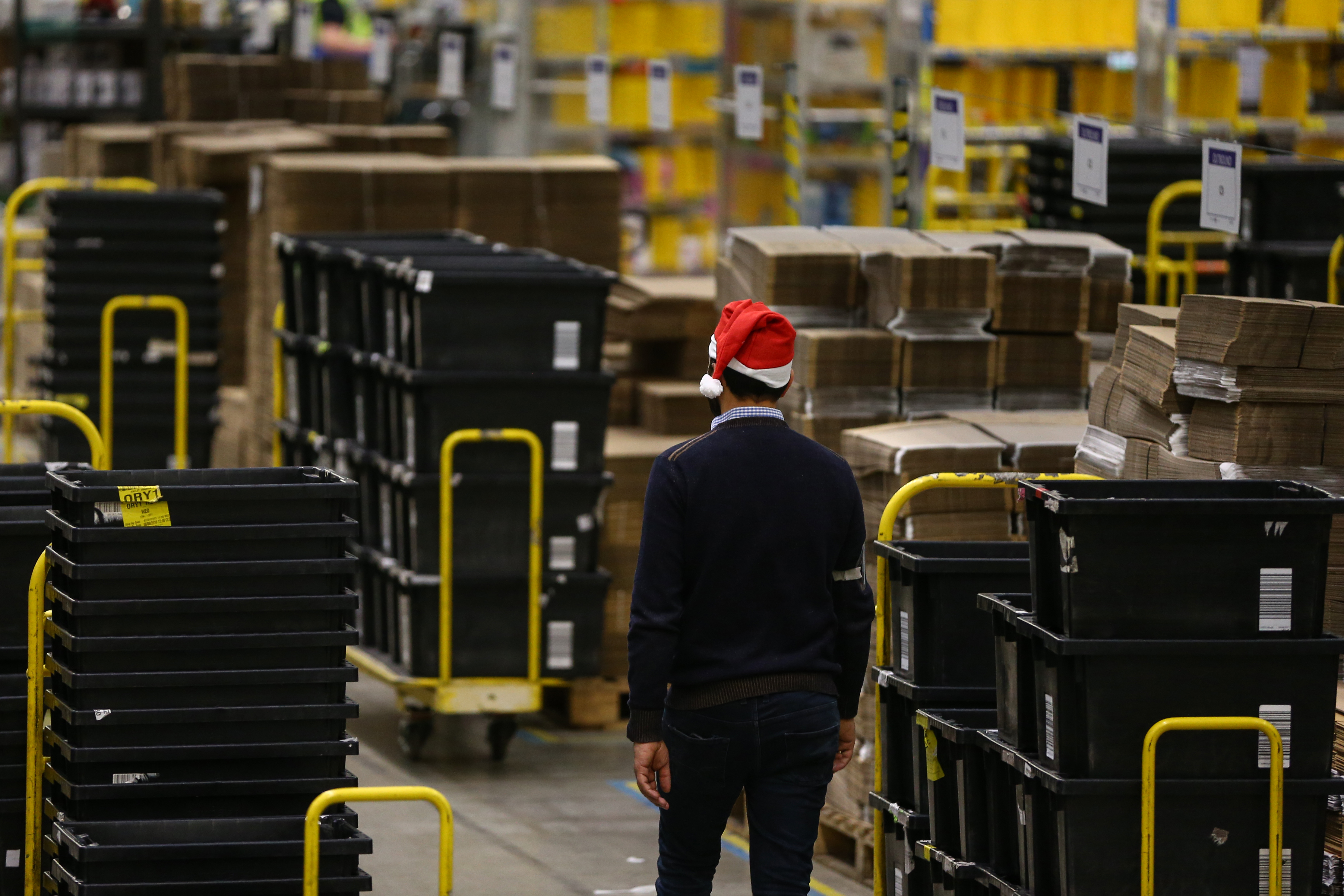 PETERBOROUGH, ENGLAND - NOVEMBER 27: (EDITORS NOTE: EMBARGOED TO 0001 ON THURSDAY NOVEMBER 28, 2019) A worker in the Peterborough Amazon Fulfilment Centre prepares for Black Friday on November 27, 2019 in Peterborough, England. The Amazon Black Friday sale runs from November 22-29, with thousands of deals on the latest consumer electronics and Amazon devices as well as this year's must-have toys, games, fashion, jewellery, beauty, home items and more. (Photo by Hollie Adams/Getty Images)