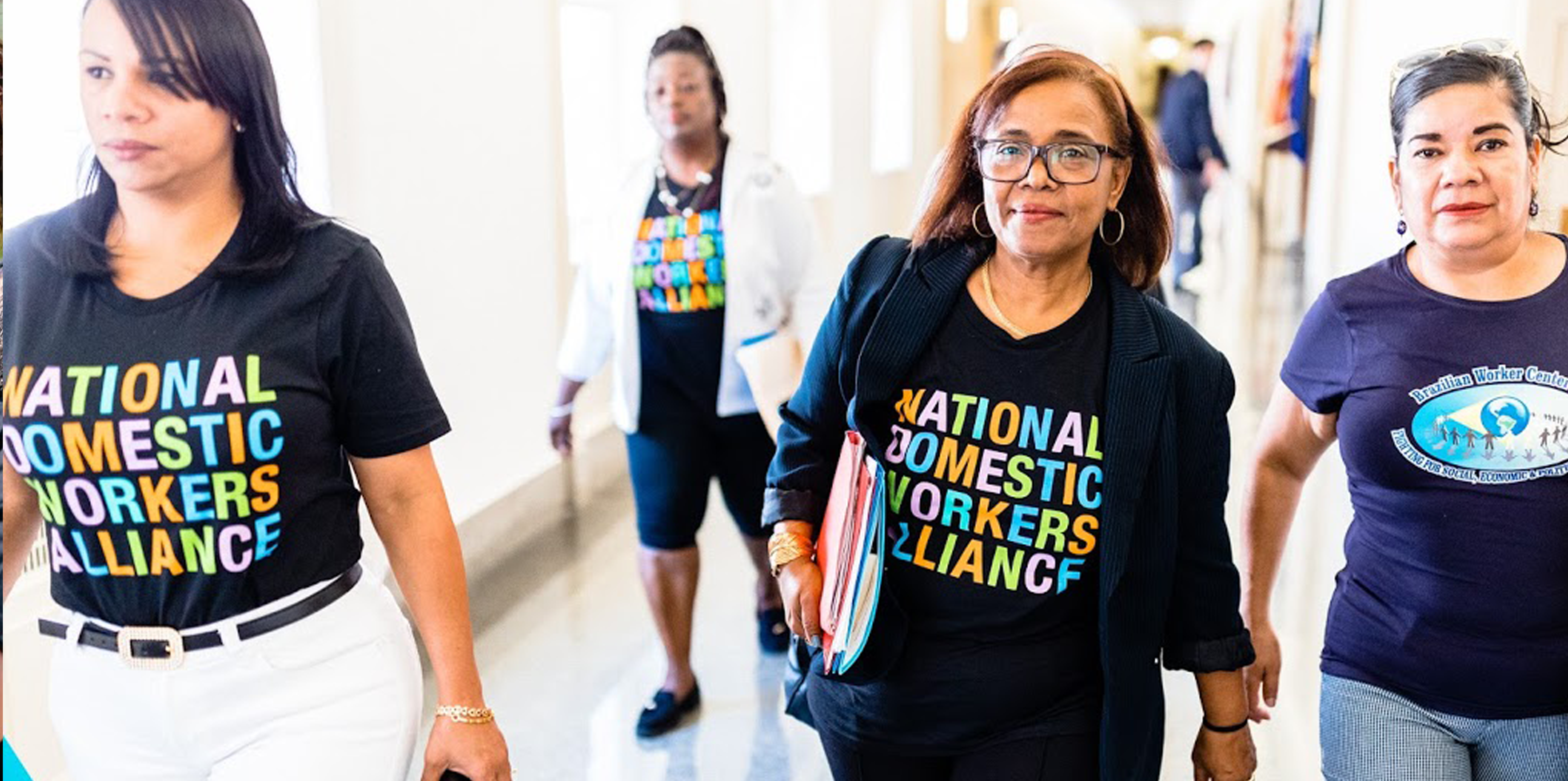 a group of women walking down a hallway