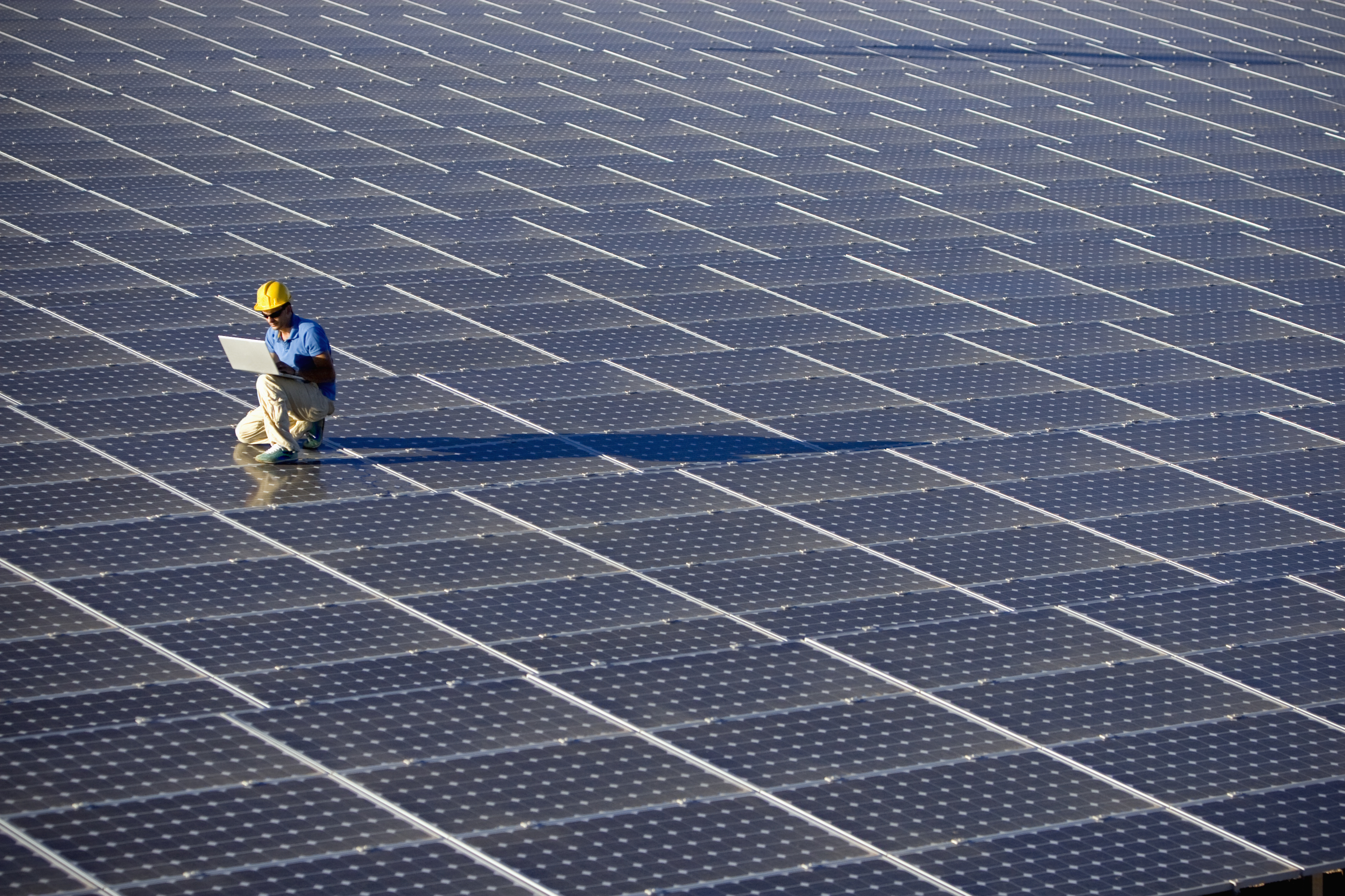 Image of a Engineer with a laptop at a photovoltaic farm (ISO 100). All my images have been processed in 16 Bits and transfer down to 8 before uploading.