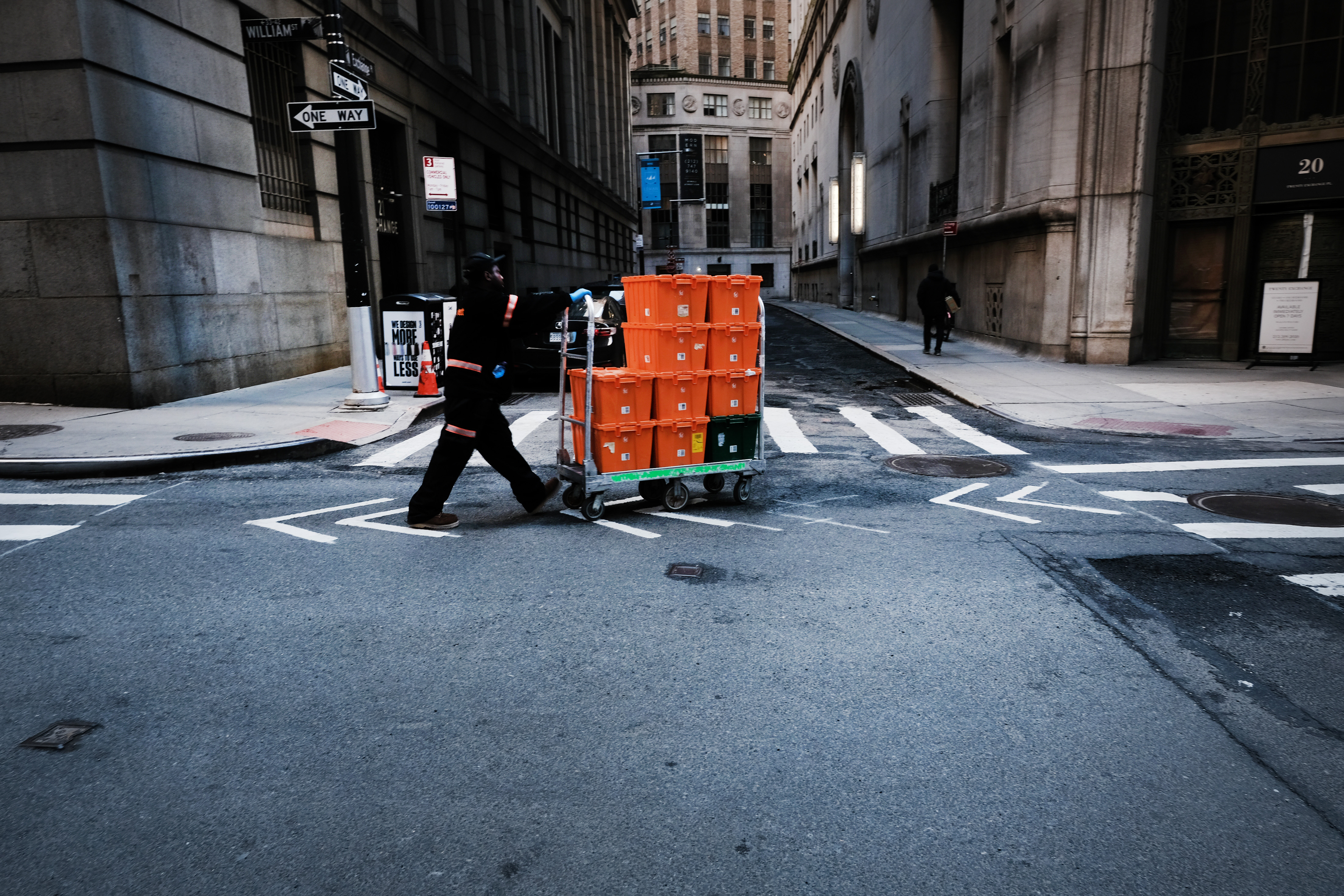 NEW YORK CITY,  - MARCH 24:  A man makes deliveries near Wall Street as people stay away from the area due to the coronavirus on March 24, 2020 in New York City. Across the country schools, businesses and places of work have either been shut down or are restricting hours of operation as health officials try to slow the spread of COVID-19.  (Photo by Spencer Platt/Getty Images)