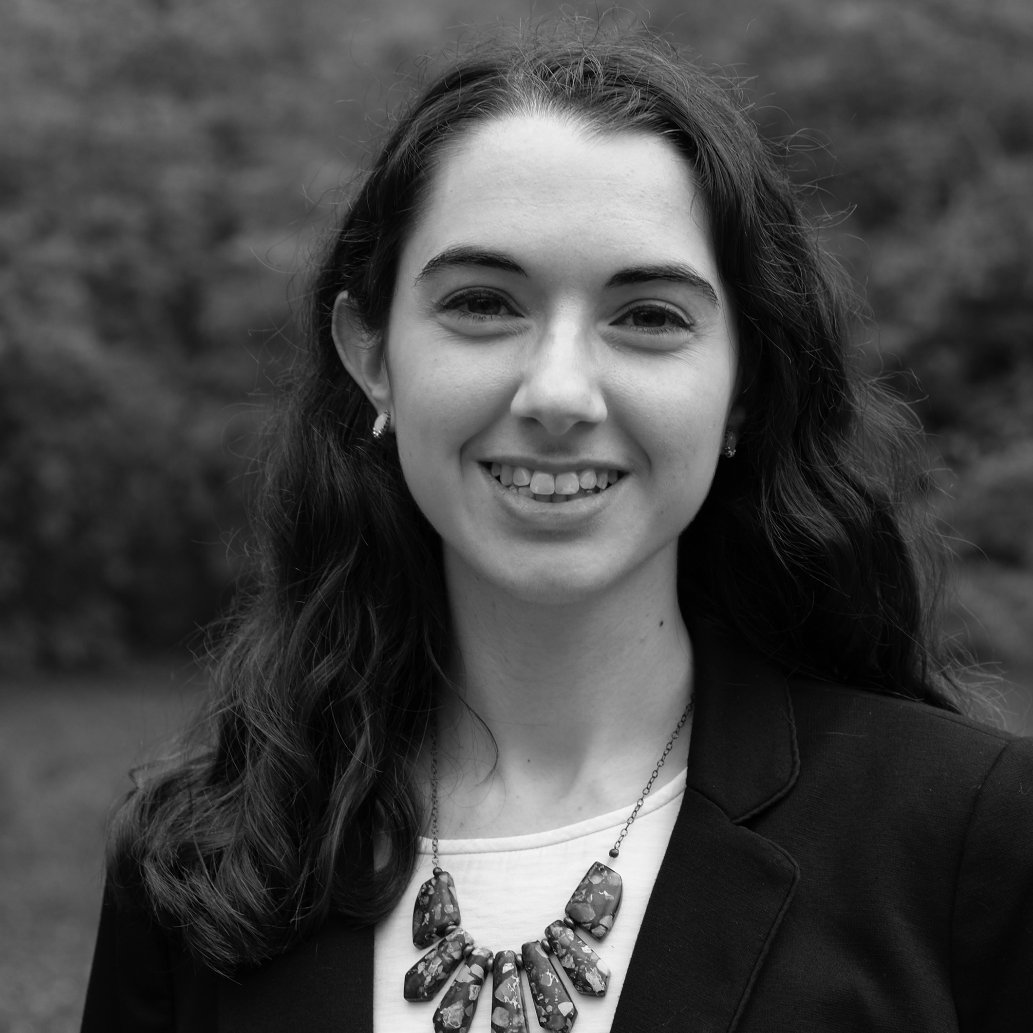 a black and white photo of a woman smiling