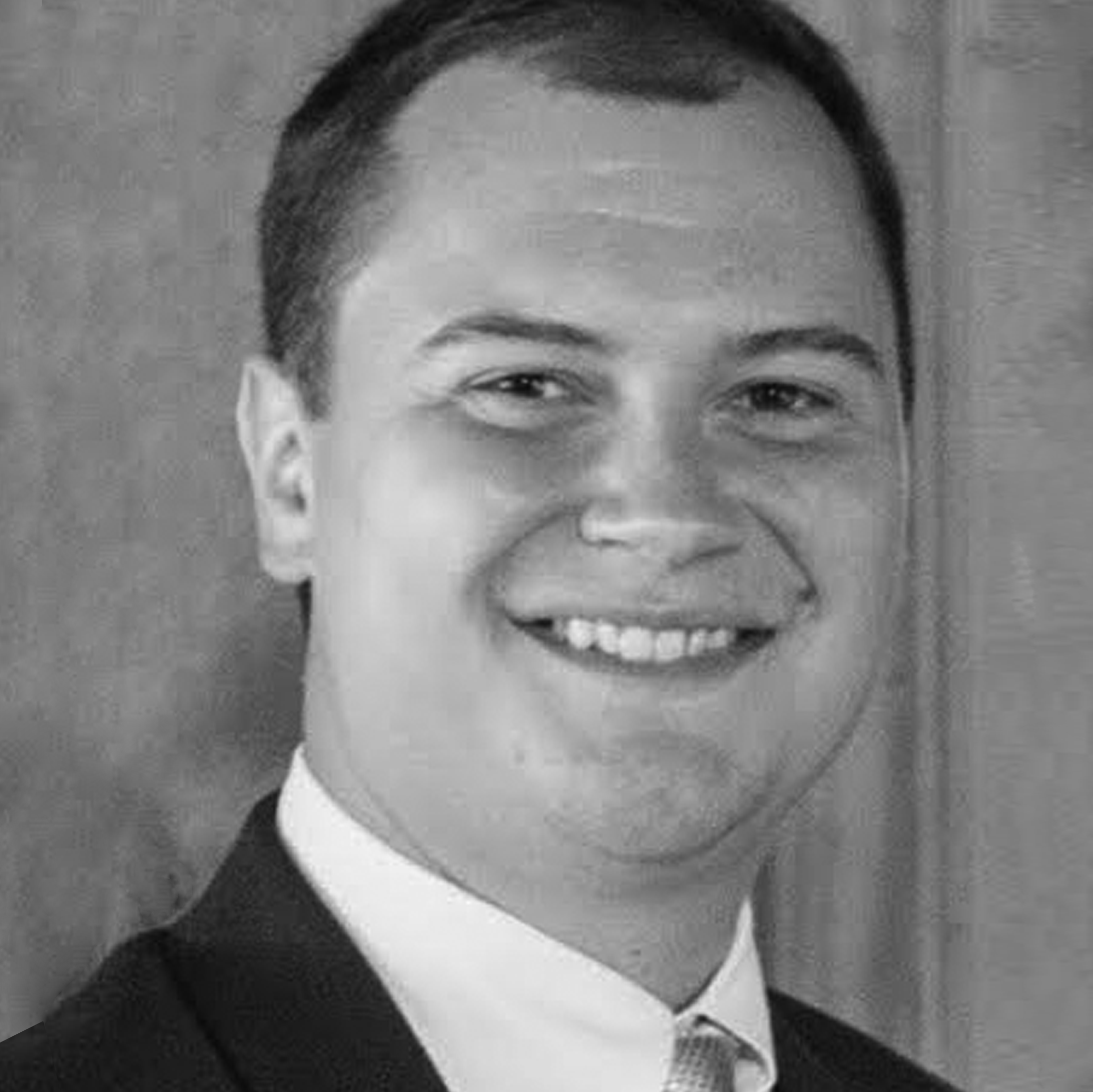 a black and white photo of a man in a suit