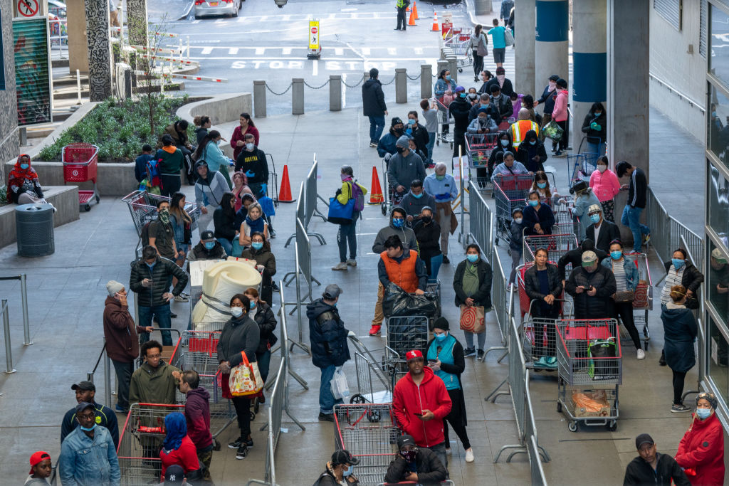 NEW YORK, NY - APRIL 08: People stand in line at East River Plaza for shopping at Costco and Target on April 8, 2020 in New York City. Businesses that remain open continue to encourage social distancing, which health experts say is in the early stages of showing results, amid the coronavirus pandemic. (Photo by David Dee Delgado/Getty Images)