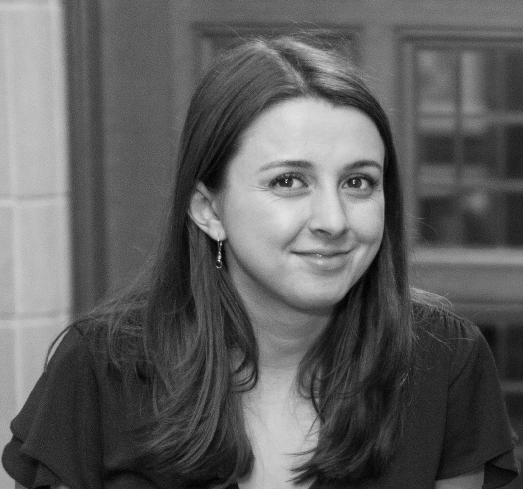 a black and white photo of a woman smiling