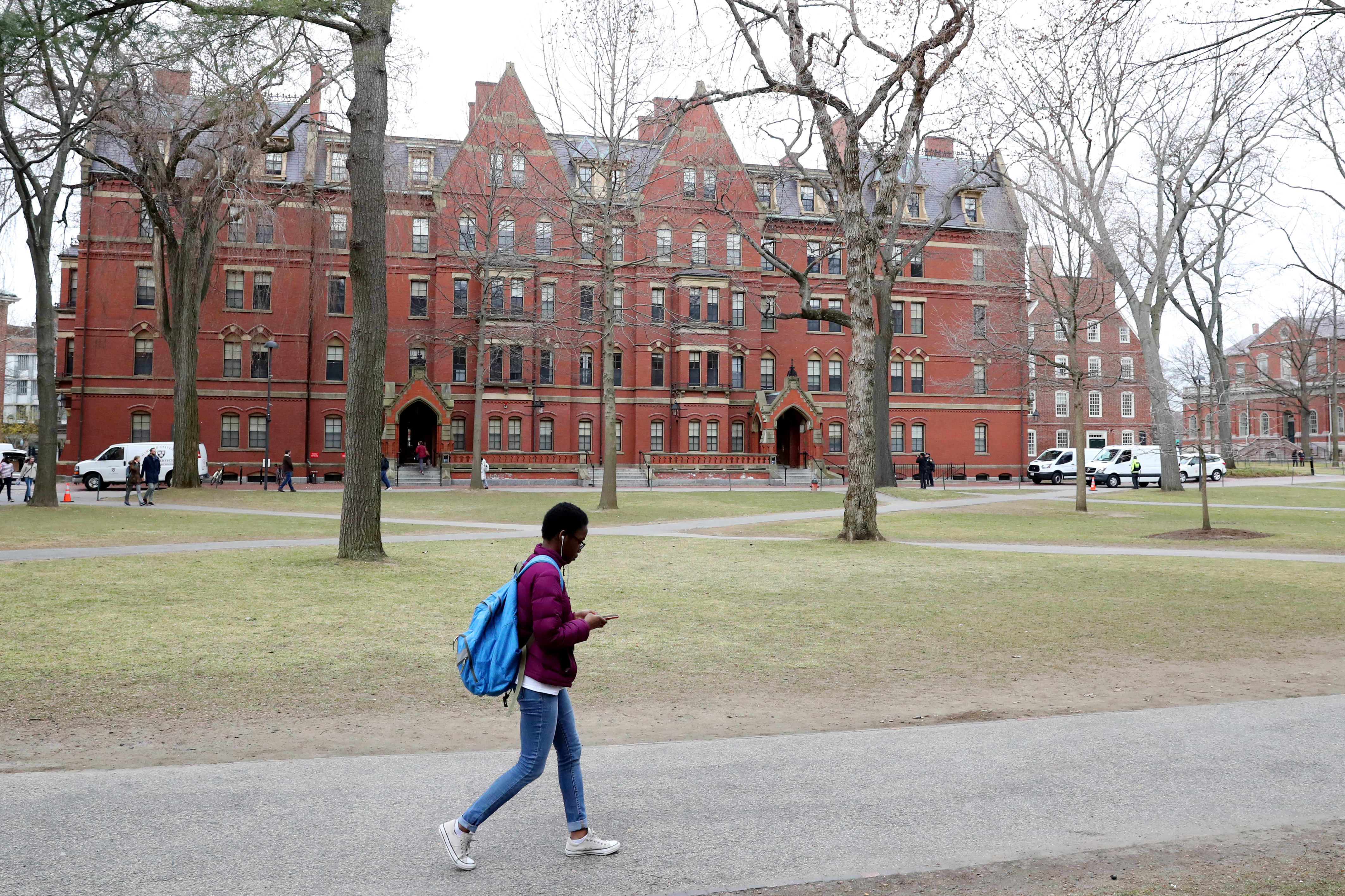CAMBRIDGE, MASSACHUSETTS - MARCH 12: A student walks through Harvard Yard on the campus of Harvard University on March 12, 2020 in Cambridge, Massachusetts. Students have been asked to move out of their dorms by March 15 due to the Coronavirus (COVID-19) risk. All classes will be moved online for the rest of the spring semester.  (Photo by Maddie Meyer/Getty Images)