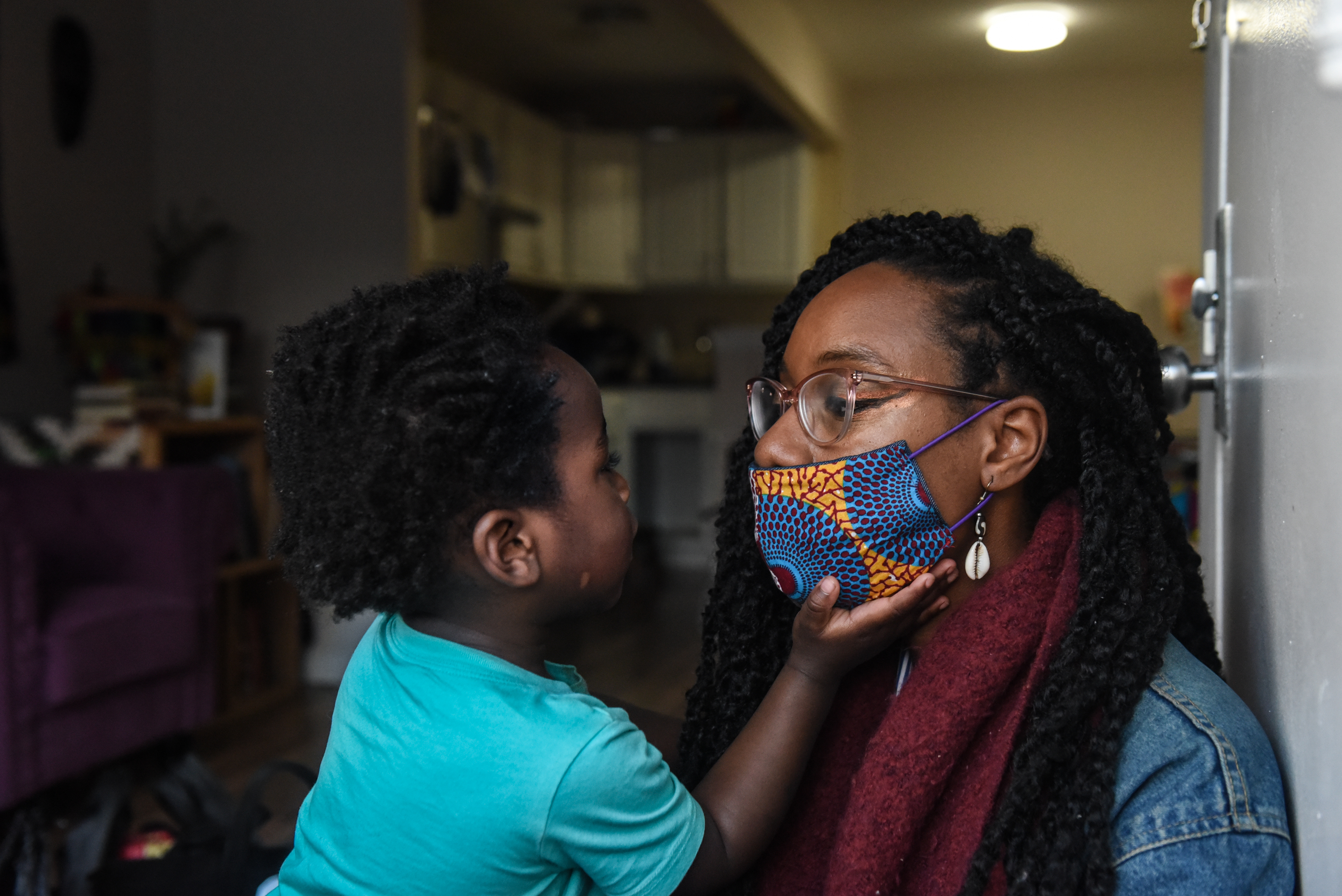 NEW YORK, NY - MAY 11 :  Sevonna Brown of Black Women's Blueprint , a mutual aid group, looks at her son, Panther Herd, 2, on May 11, 2020 in the Bedford-Stuyvesant neighborhood in the Brooklyn borough in New York City. Neighborhood mutual aid groups have been cropping up across New York City in an effort to address the economic impact of eight weeks of economic lockdown and the resulting loss of income. Mutual aid provides free food and essential items to communities most in need. Black Woman's Blueprint runs a van called Sistas Van that visits low-income communities of color. (Photo by Stephanie Keith/Getty Images)