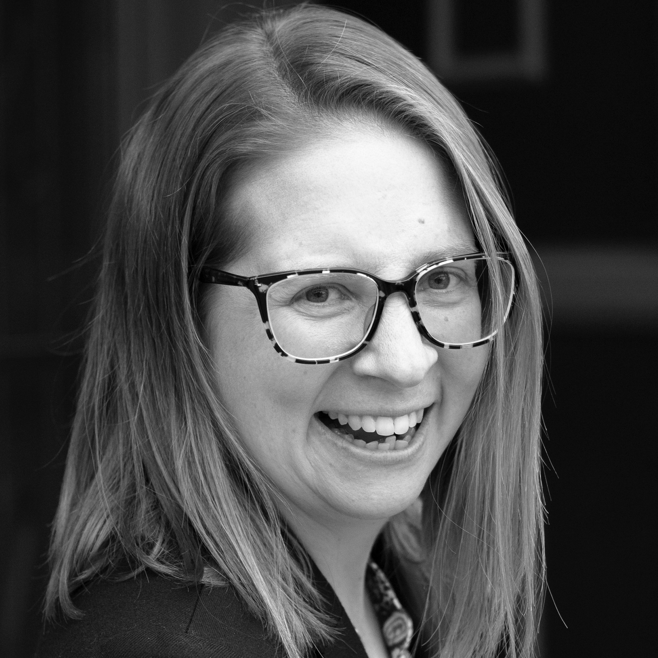 a black and white photo of a woman wearing glasses