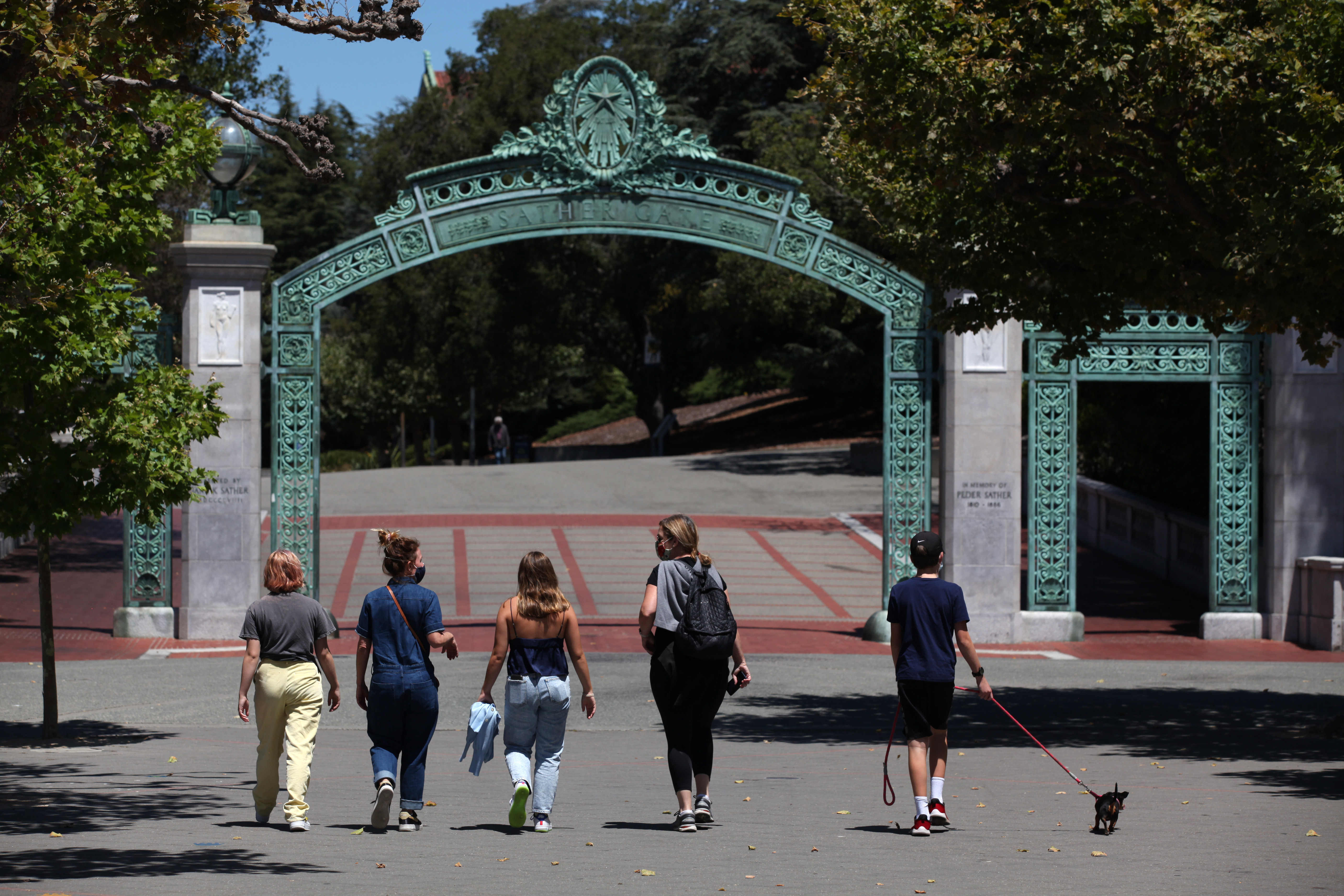 BERKELEY, CALIFORNIA - JULY 22: People walk towards Sather Gate on the U.C. Berkeley campus on July 22, 2020 in Berkeley, California. U.C. Berkeley announced plans on Tuesday to move to online education for the start of the school's fall semester due to the coronavirus COVID-19 pandemic. (Photo by Justin Sullivan/Getty Images)
