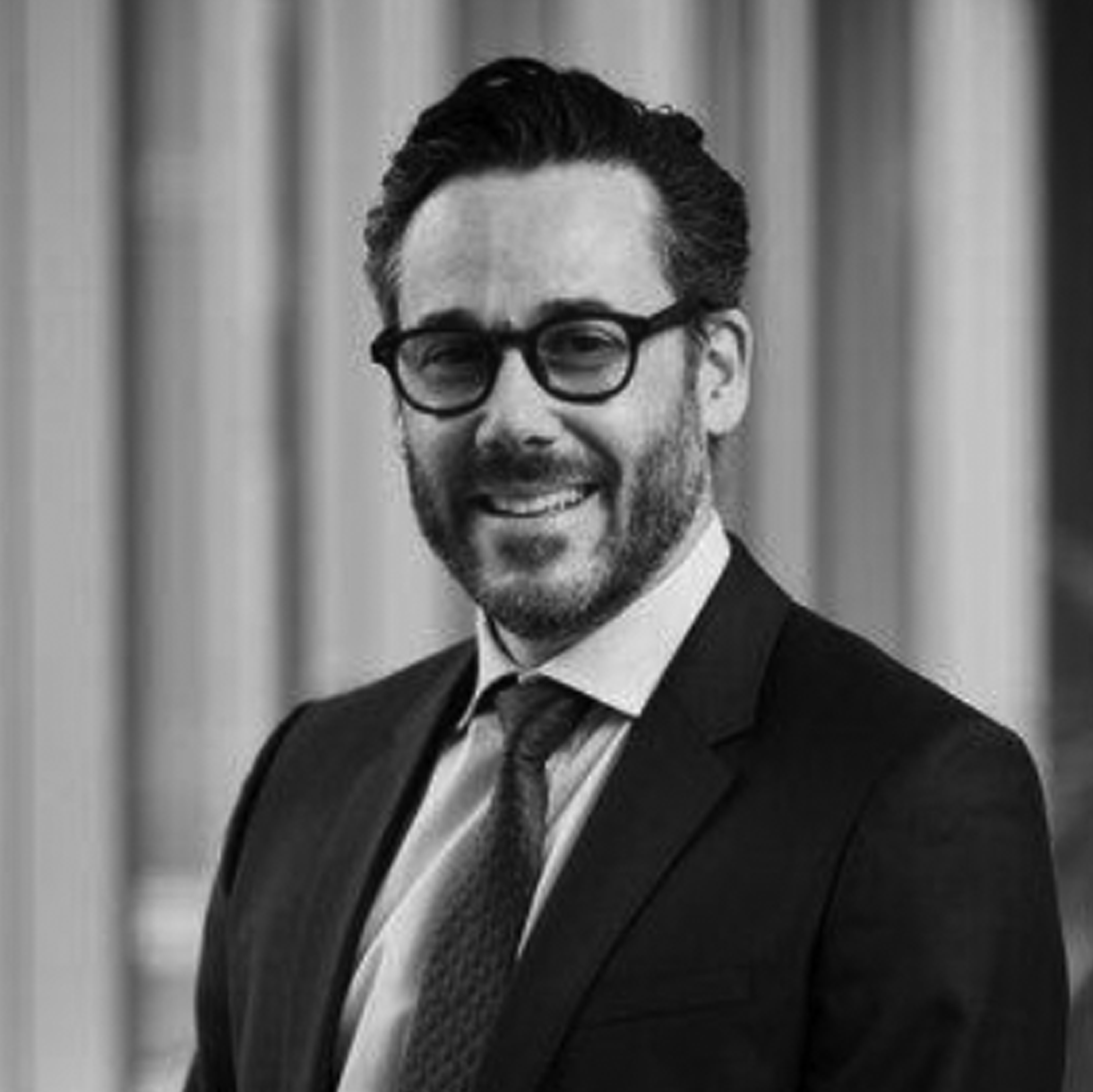 a black and white photo of a man in a suit and tie