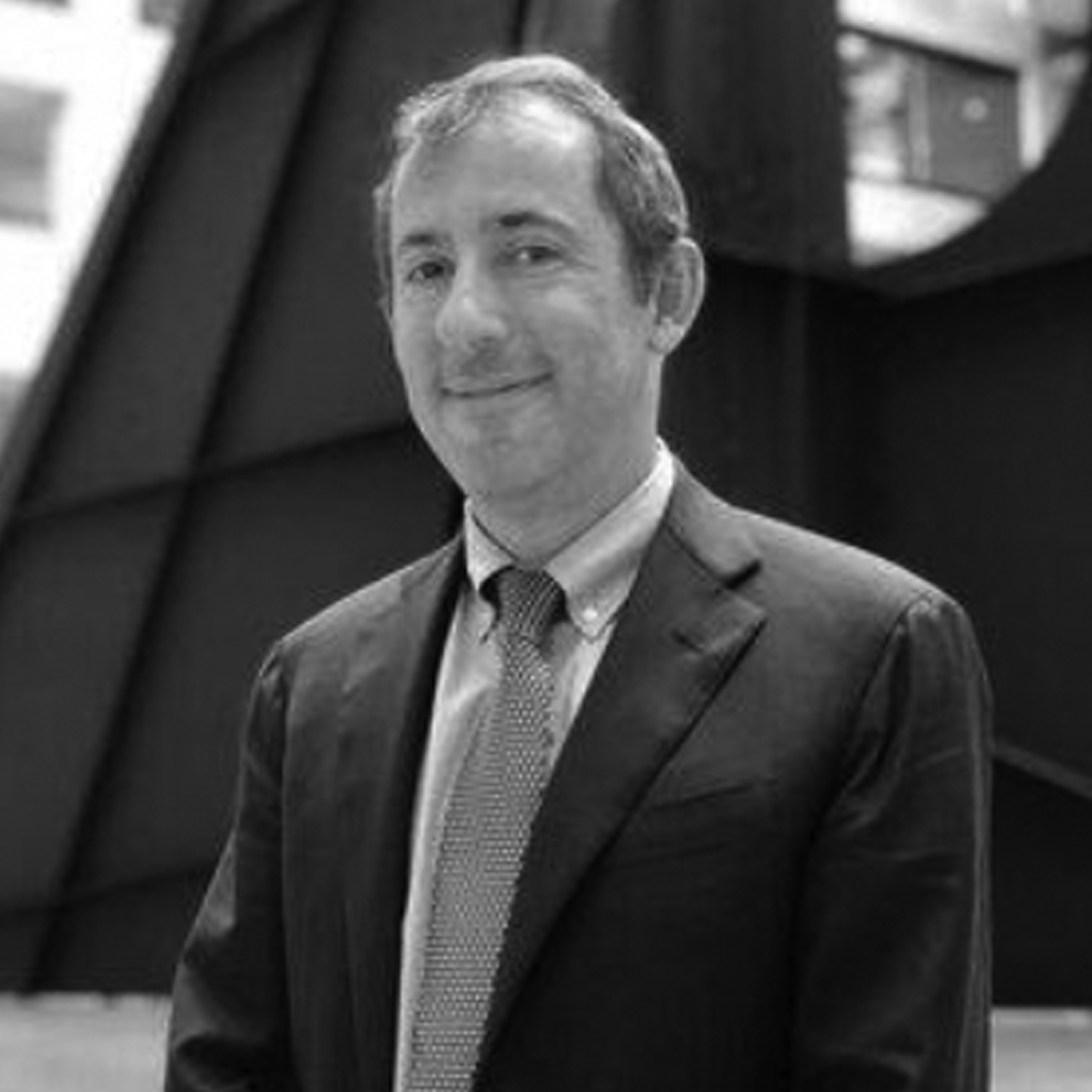 a black and white photo of a smiling man