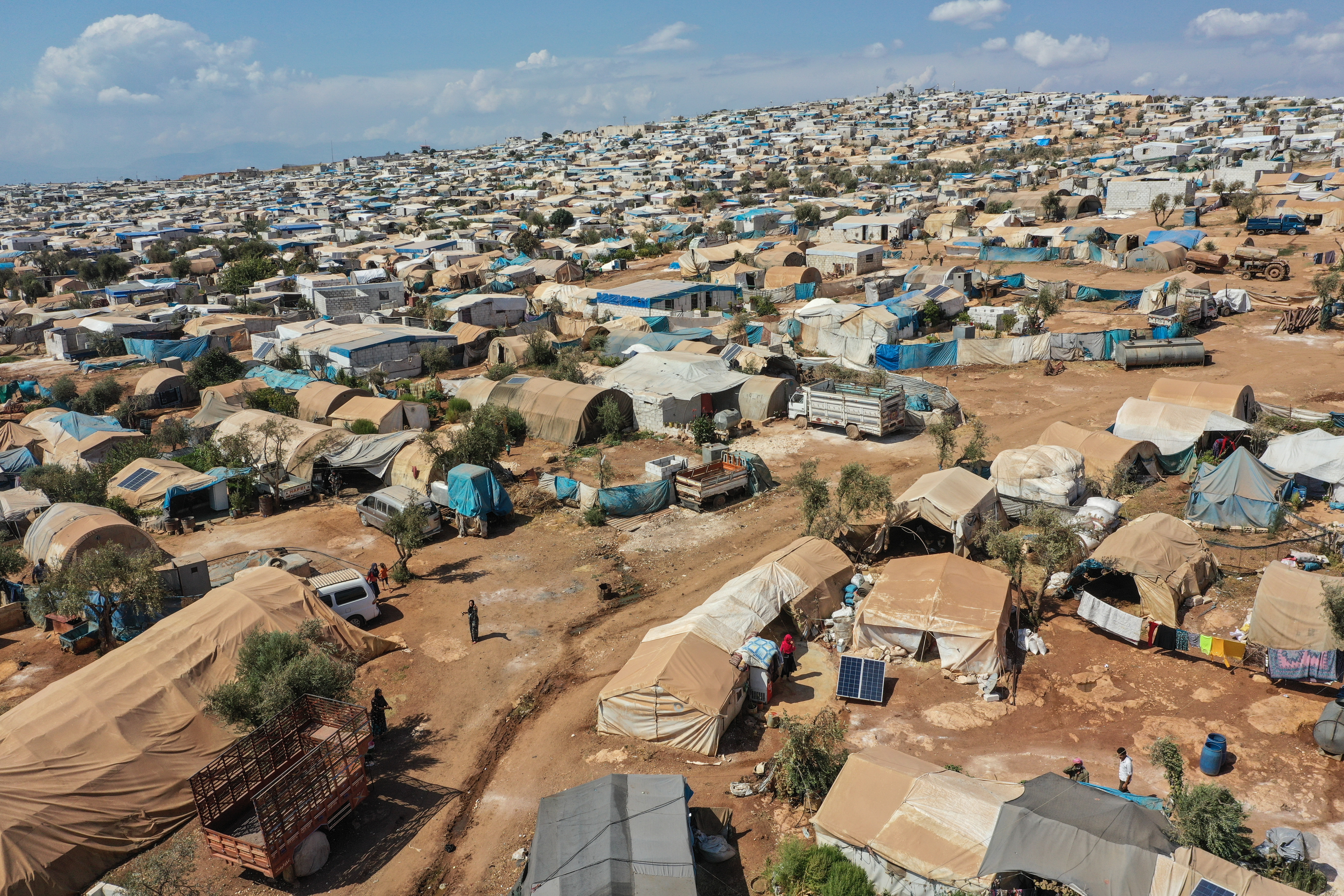ATMEH, SYRIA - SEPTEMBER 17: A general view of the village of Atmeh which hosts nearly 1 million displaced Syrians near the Syrian-Turkish border in Idlib Province September 17, 2019 in Atmeh, Syria. Turkey’s president, Recep Tayyip Erdogan, is pushing for the creation of an expanded “safe zone” in northern Syria where his government hopes to resettle up to three million Syrian refugees. The United States and Turkey recently started joint patrols of a small buffer zone along the border, but it’s a far cry from the 20-by-300 mile strip proposed by Mr. Erdogan, and no other power involved in the war as agreed to the idea. Turkey has warned that, if it doesn’t receive more international support for the safe zone, it might relax its migration controls and reopen the route for refugees to enter Europe. More than 3.6 million Syrian refugees have settled in Turkey after fleeing the civil war that began in 2011. (Photo by Burak Kara/Getty Images)