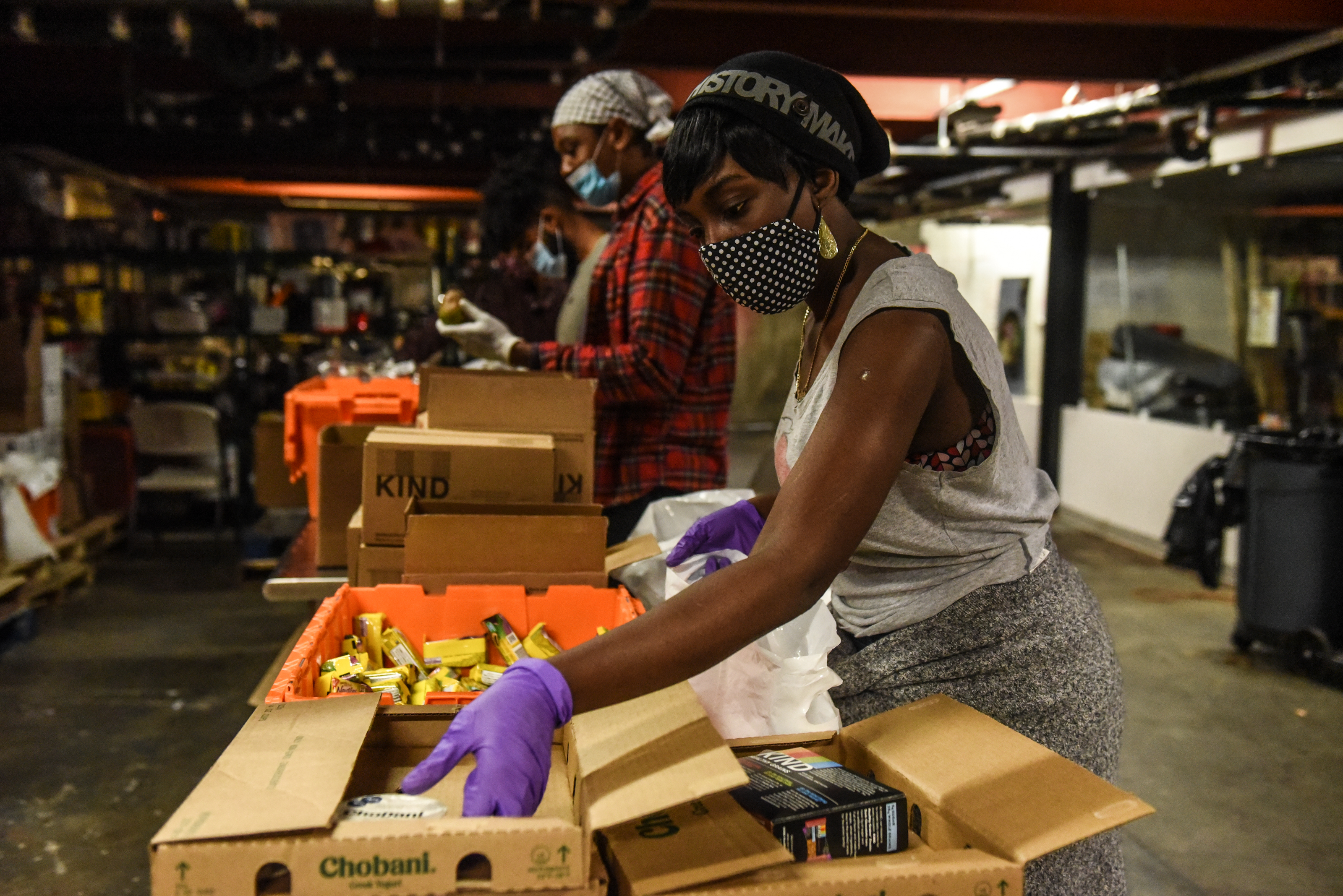 NEW YORK, NY - MAY 20 :  Employees work to create to- go donation meals for a company called Collective Fare on May 20, 2020 in the Brownsville neighborhood in the Brooklyn borough in New York City. Collective Fare works with World Central Kitchen to get raw ingredients that they cook into gourmet meals. New York City is currently in its ninth week of lockdown with non-essential businesses still closed. (Photo by Stephanie Keith/Getty Images)