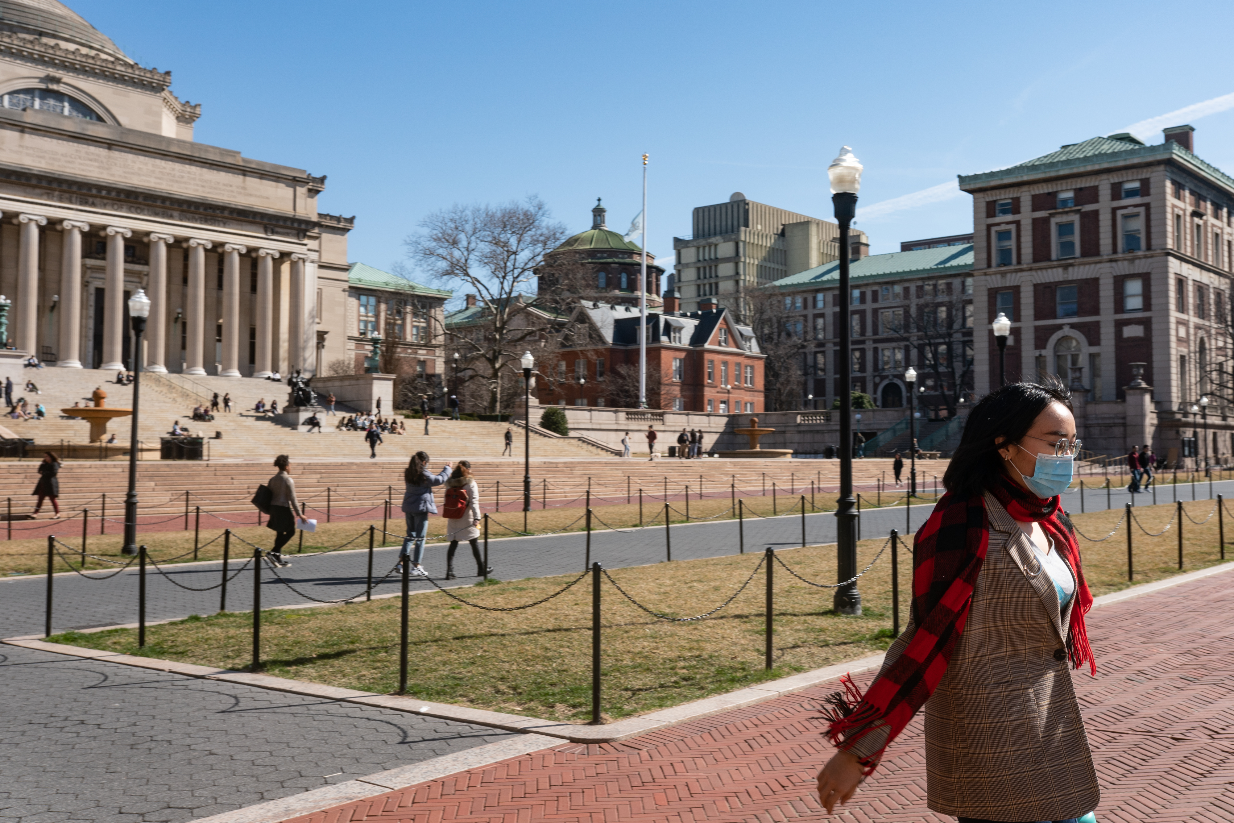 NEW YORK, NY - MARCH 09: A woman wearing a protective mask walks on the Columbia University campus on March 9, 2020 in New York City. The university is canceling classes for two days after a faculty member was quarantined for exposure to the novel coronavirus. The remainder of the week would be taught remotely. (Photo by Jeenah Moon/Getty Images)
