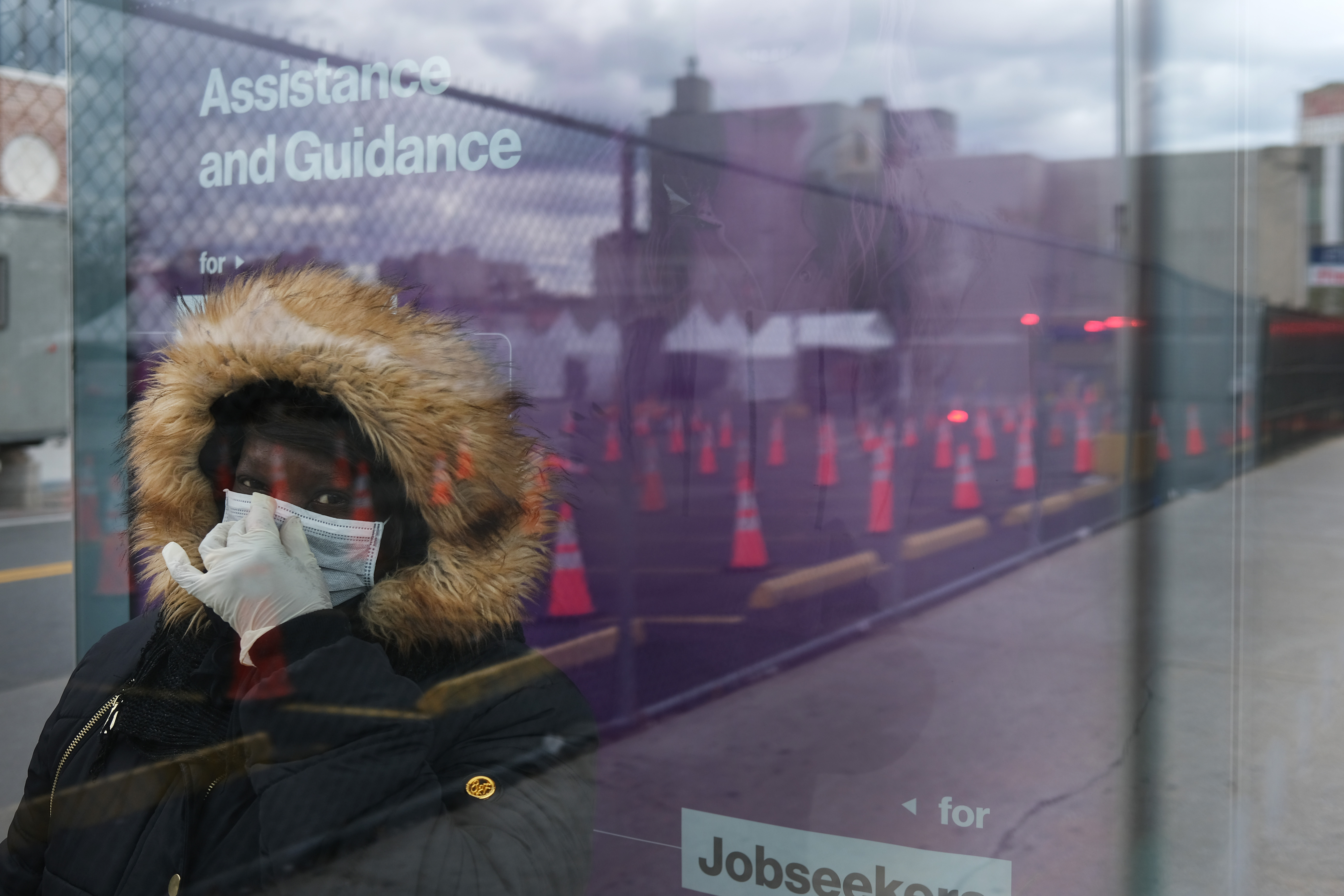 NEW YORK, NY - APRIL 10: A woman waits for a bus near a coronavirus testing site in Brooklyn on April 10, 2020 in the Brooklyn borough of New York City. According to John Hopkins University, the global death toll from COVID-19 has now reached 100,000 worldwide with many experts believing that the number is actually higher.   (Photo by Spencer Platt/Getty Images)